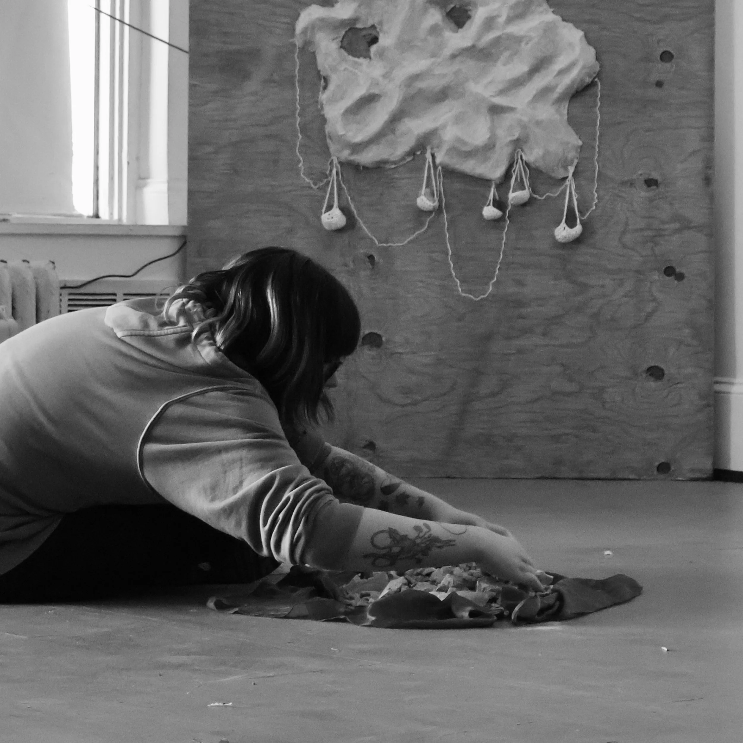 "You Were Hard to Get Here", 2025, Performance of  placing raw earthenware clay with poetry carved into it on silk
