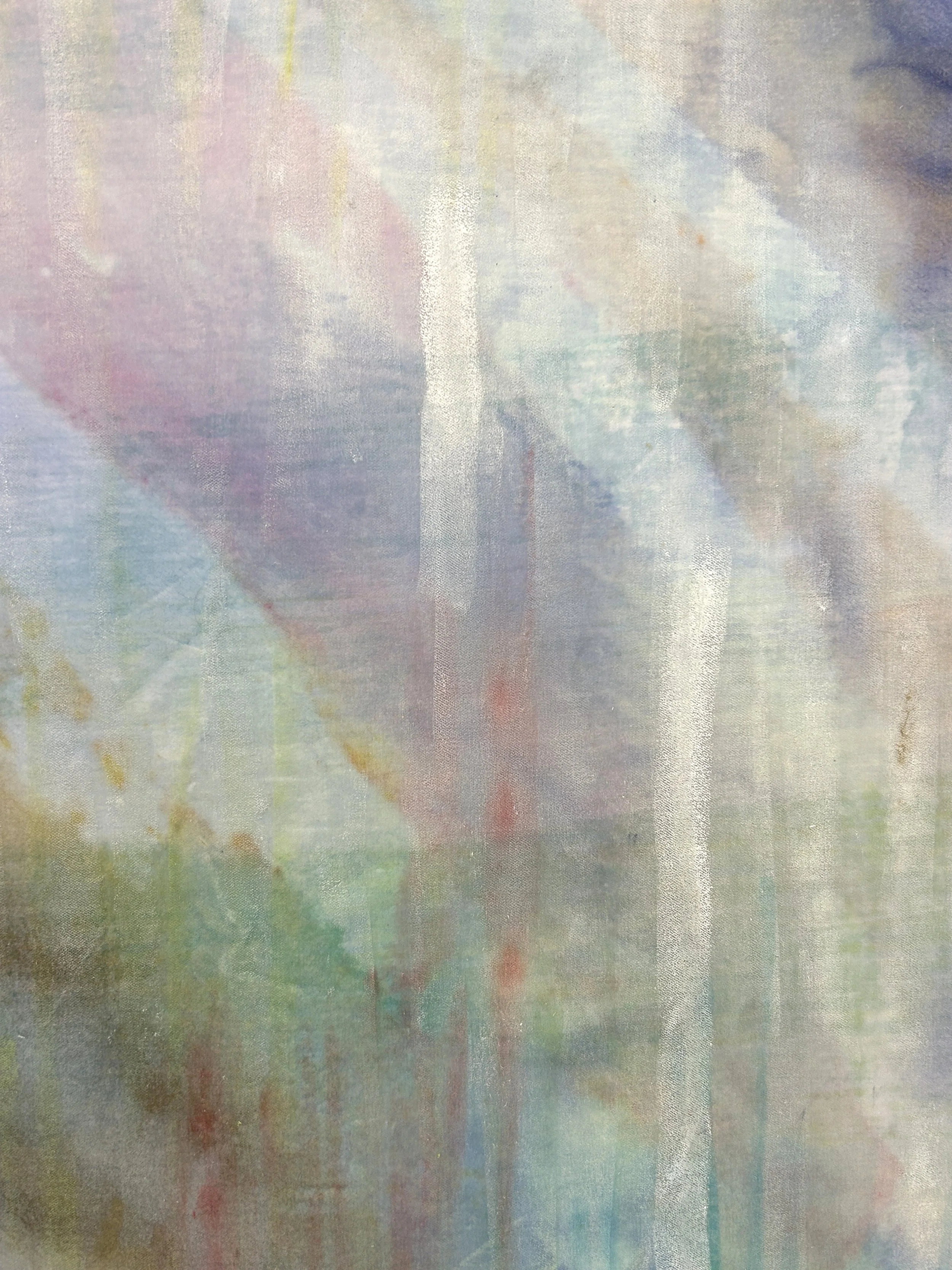 Close-up of a textured, abstract surface with streaks of white on purple, blue and green.