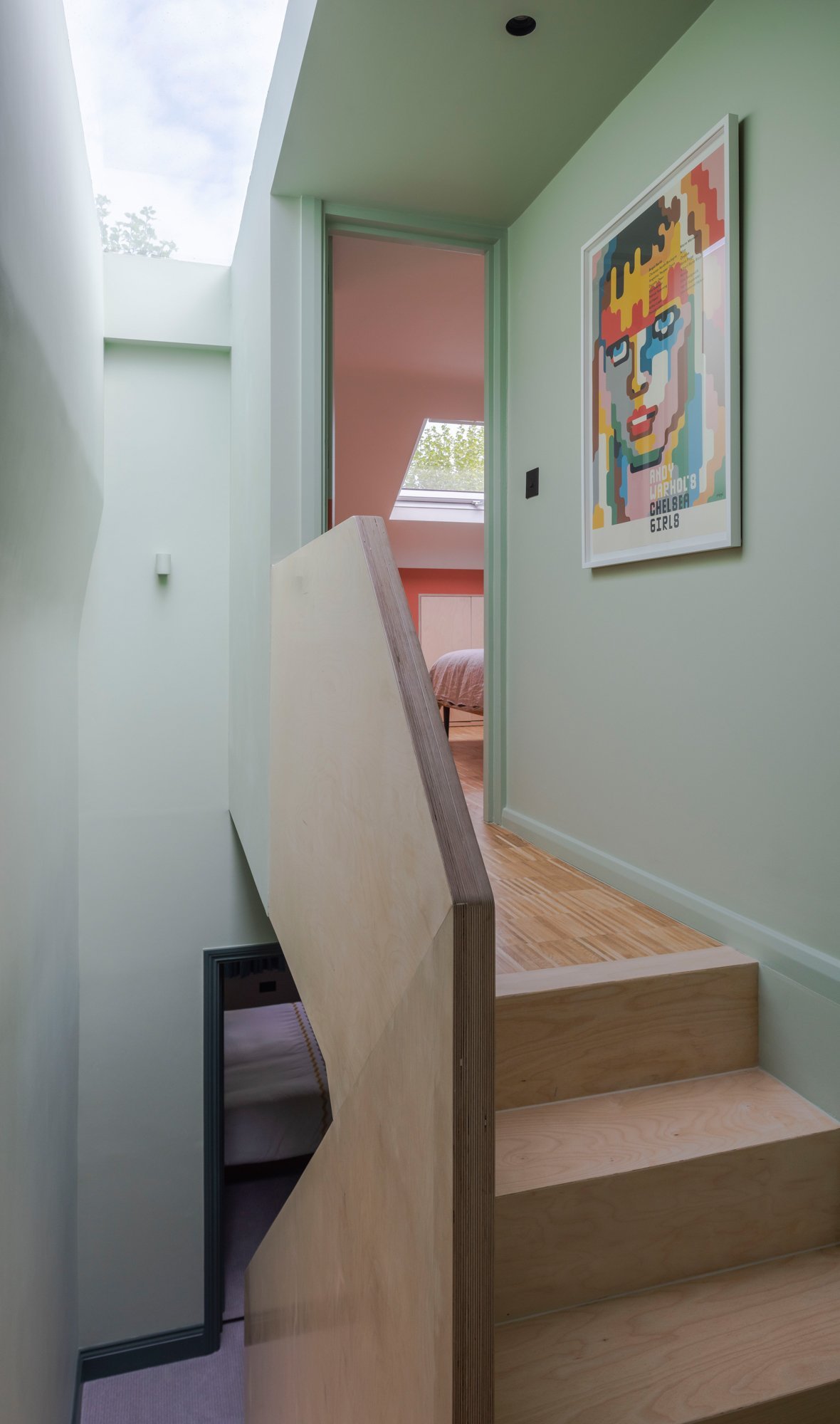 Floor to ceiling pale green works so well in this hallway. It shifts to a lighter tone as it reaches the roof light.