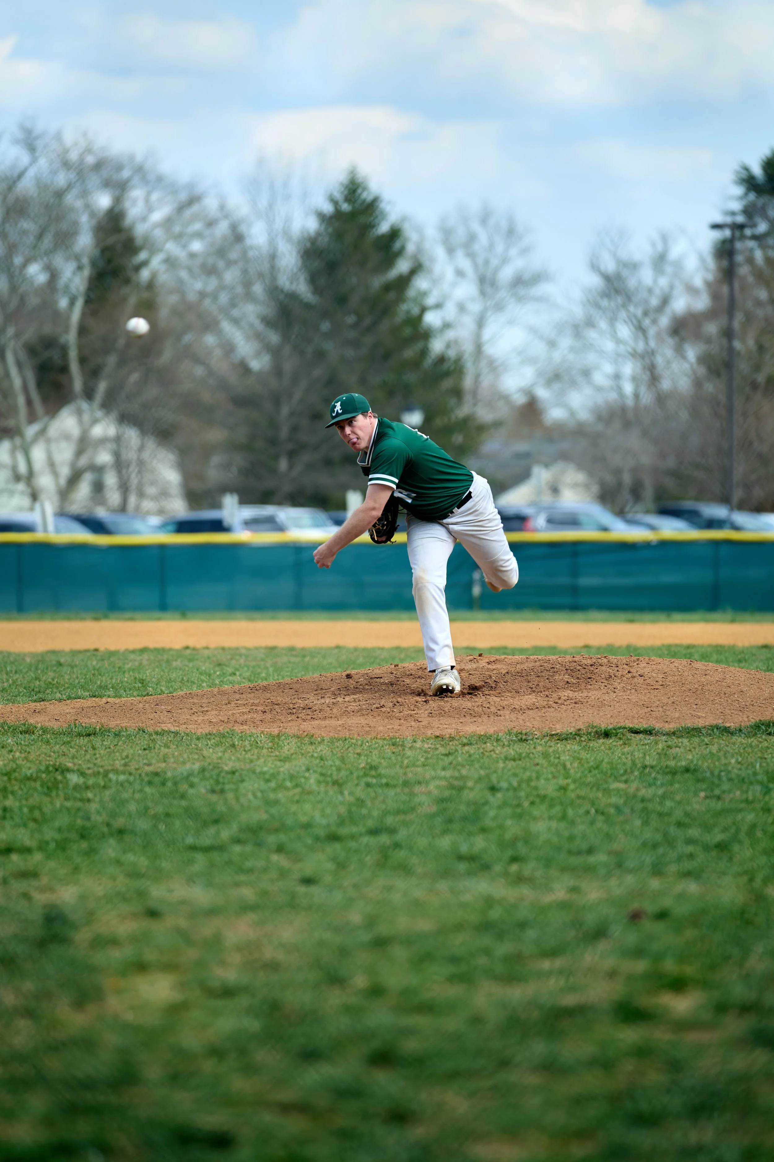 Baseball player pitching on the field during a game.