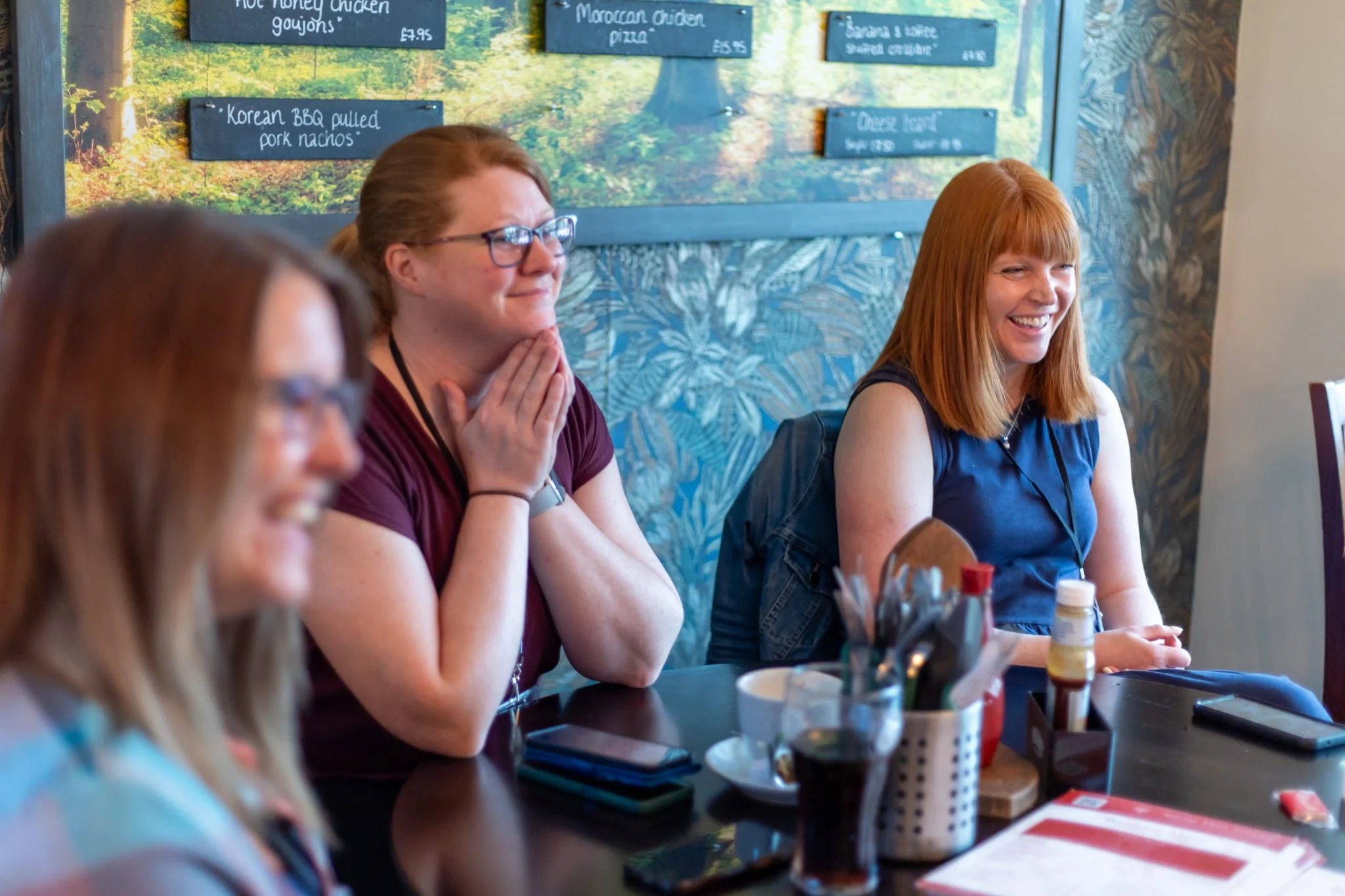 Penny at a networking session laughing at the table