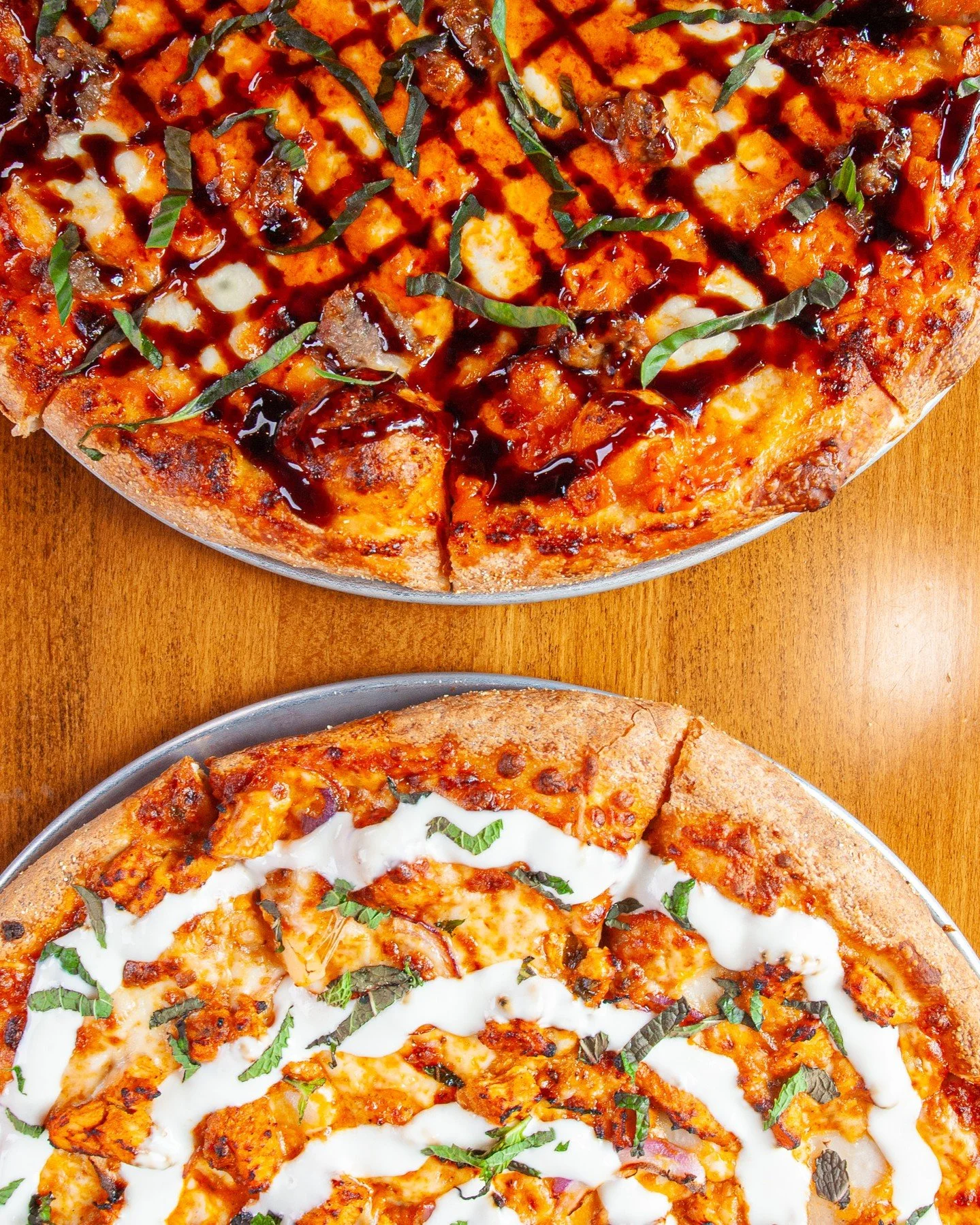 Our two new featured pizzas JUST hit the table today and it's time to say hello! 🍕✨⁠
⁠
La Vodka Bella 🍅⁠
House-made vodka sauce, fresh mozzarella, diced garlic, BCP sausage, fresh basil, finished with a balsamic glaze.⁠
⁠
Masala Butter Chicken 🍗⁠
