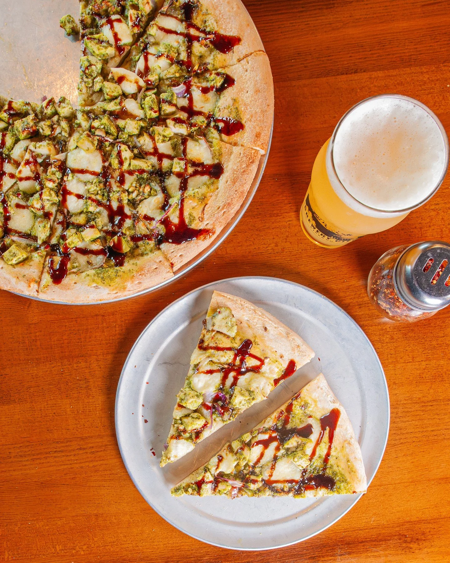 Have you tried our Pesto Primavera Chicken Pizza yet? ⁠
⁠
💚 Basil pesto base topped with fresh mozzarella, red onion, garlic, pesto-marinated diced chicken, cashews, crushed red pepper flakes, and a balsamic glaze drizzle 💚⁠
⁠
Grab a Large or Giant