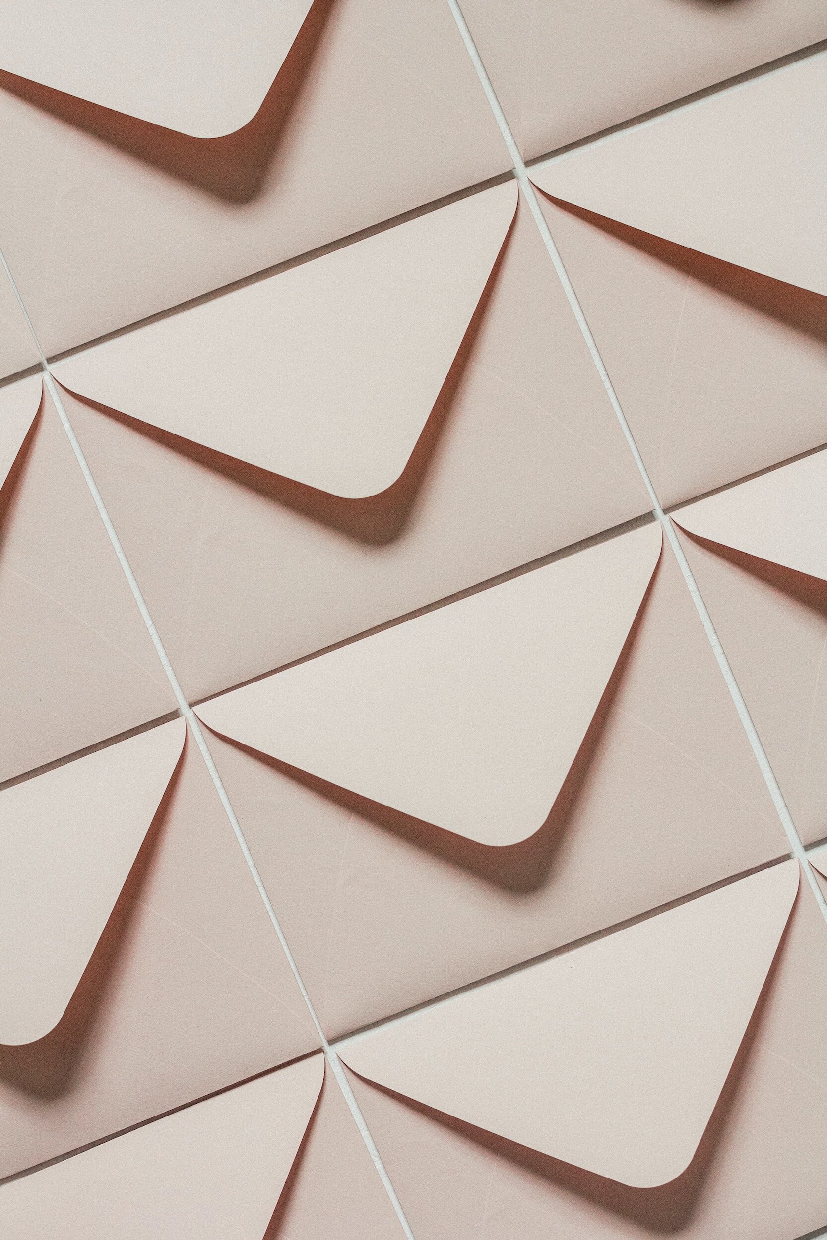 Geometric pattern with overlapping triangles and shadows on a beige background