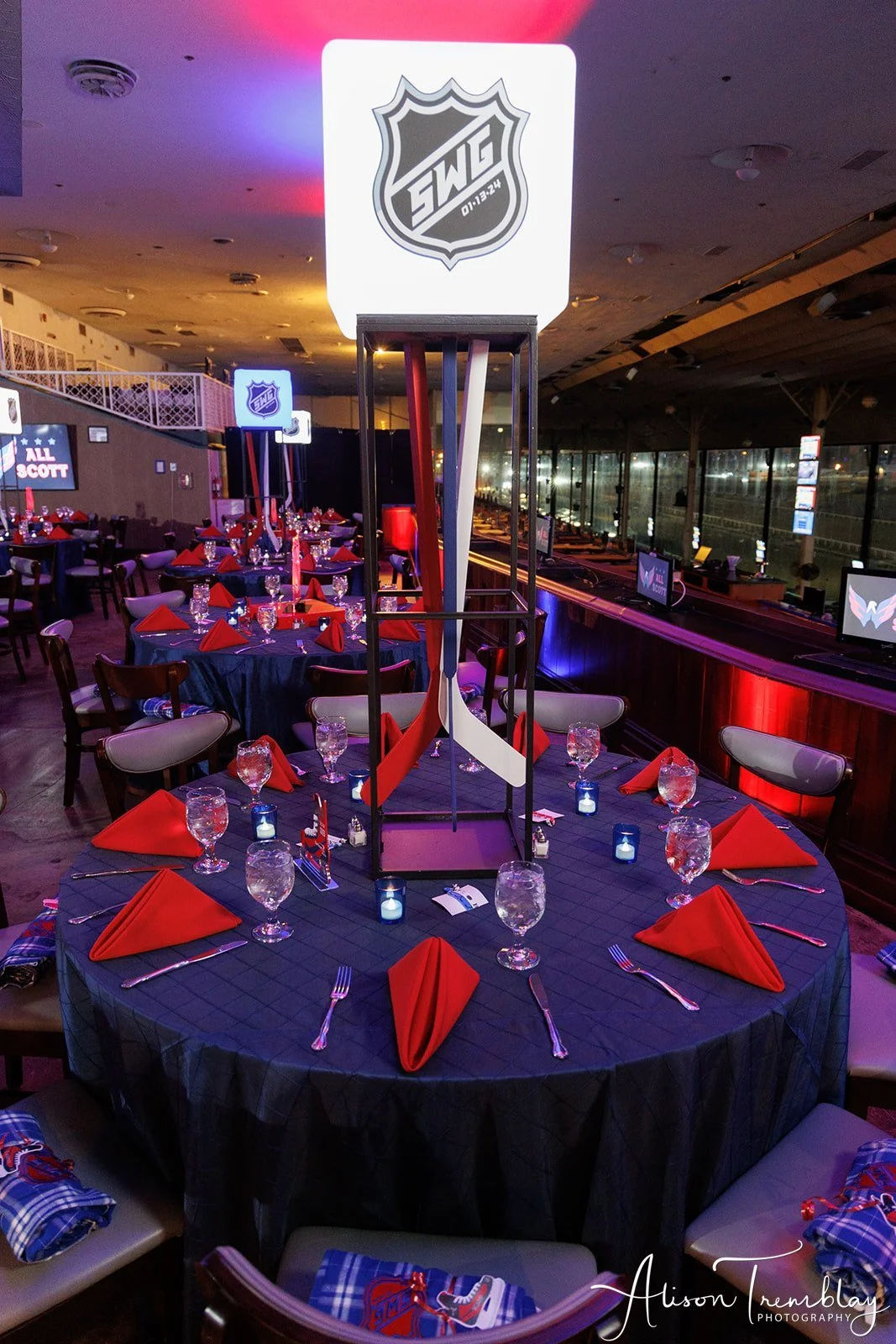 close up blue table with red napkins tall hockey glow centerpiece