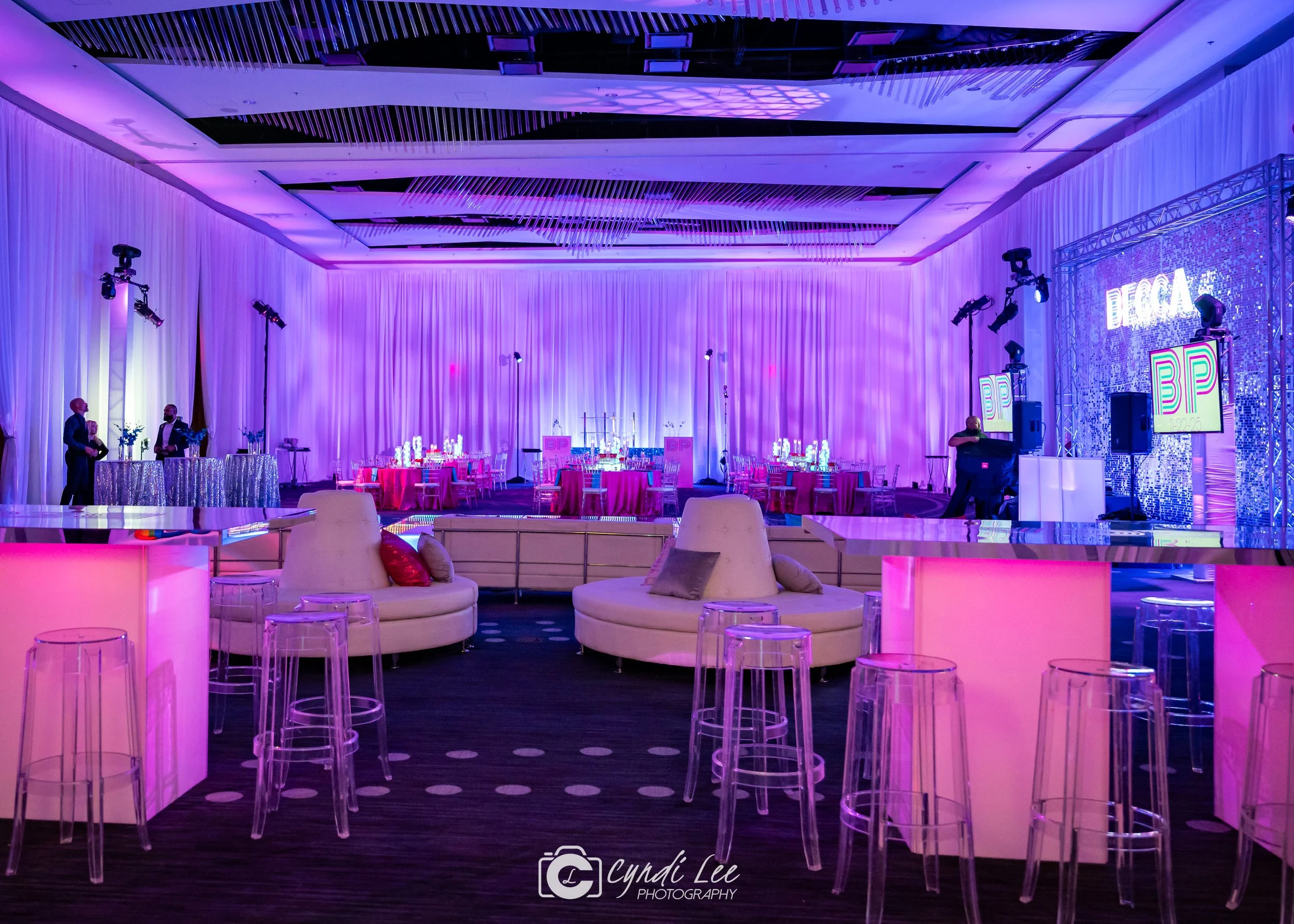 pink and blue lighting wash with white lounge furniture