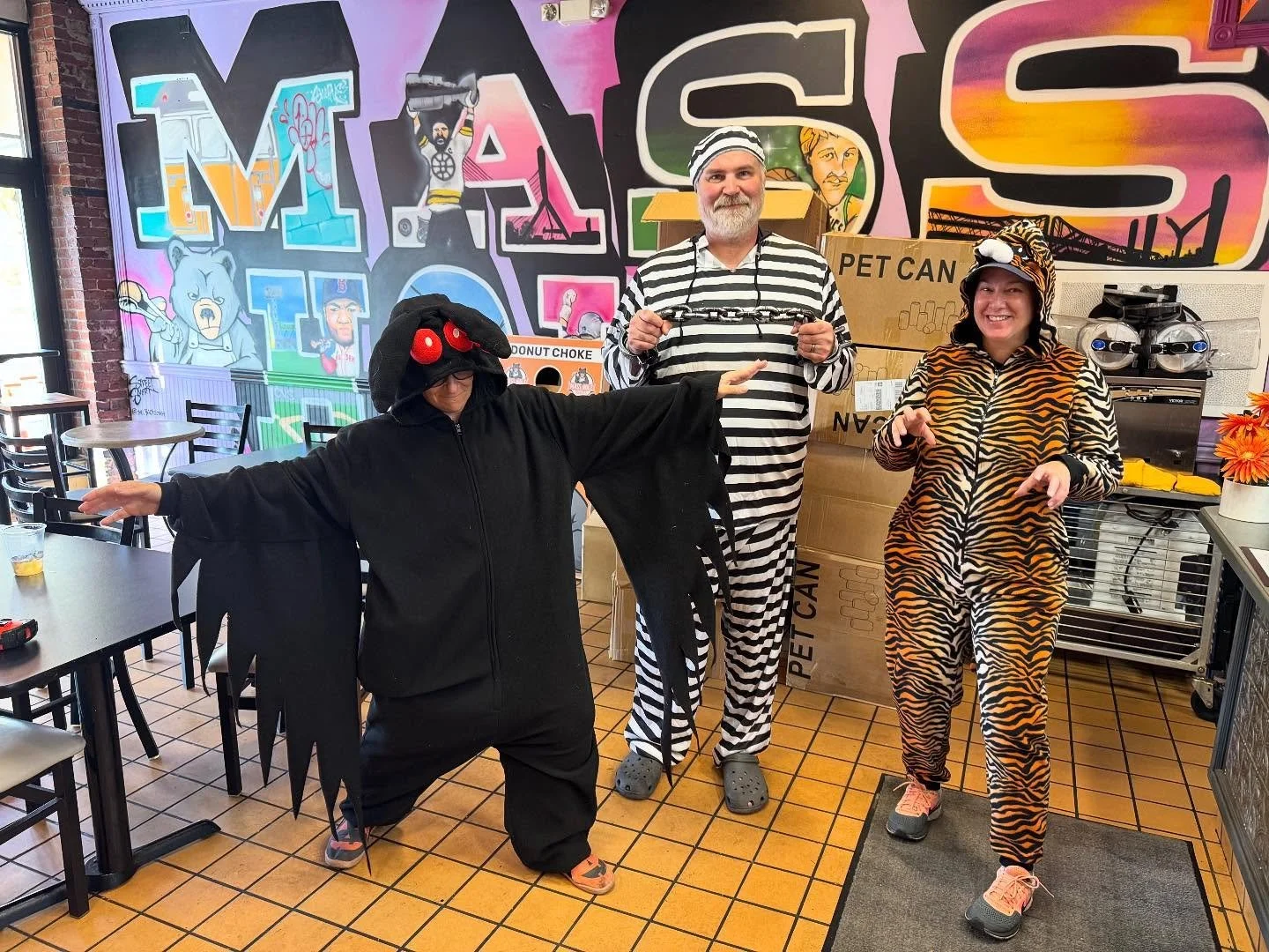 STAFF HALLOWEEN COSTUME CONTEST &mdash; YOUR VOTE COUNTS!
Meet our contenders:

Mothman &mdash; lurking in the shadows, wings spread, ready to spook.

Tiger &mdash; fierce stripes, wild eyes, the jungle comes to the shop.

Escaped Convict &mdash; str