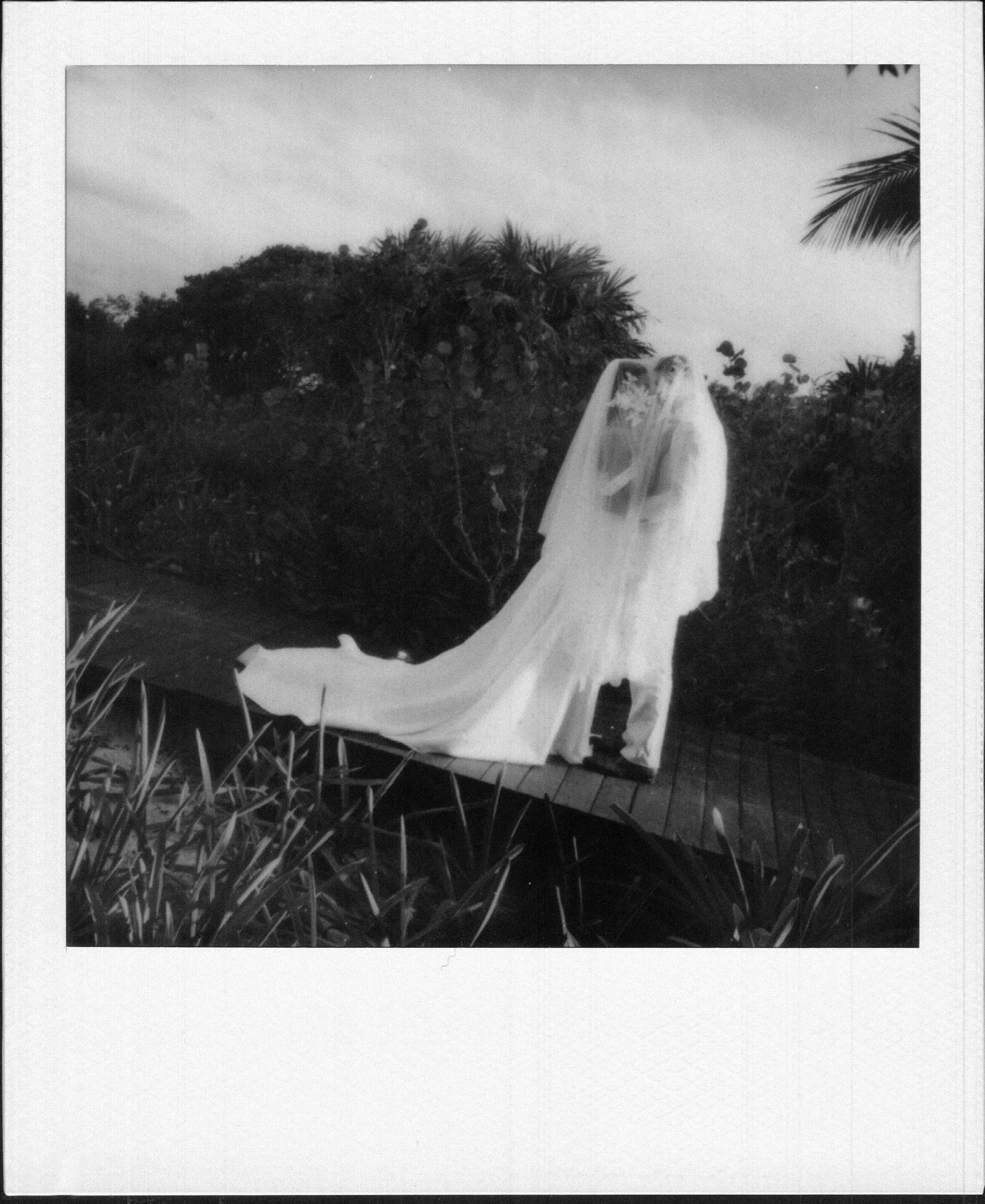 wedding film photography in polaroid of a bride and a groom during their wedding day