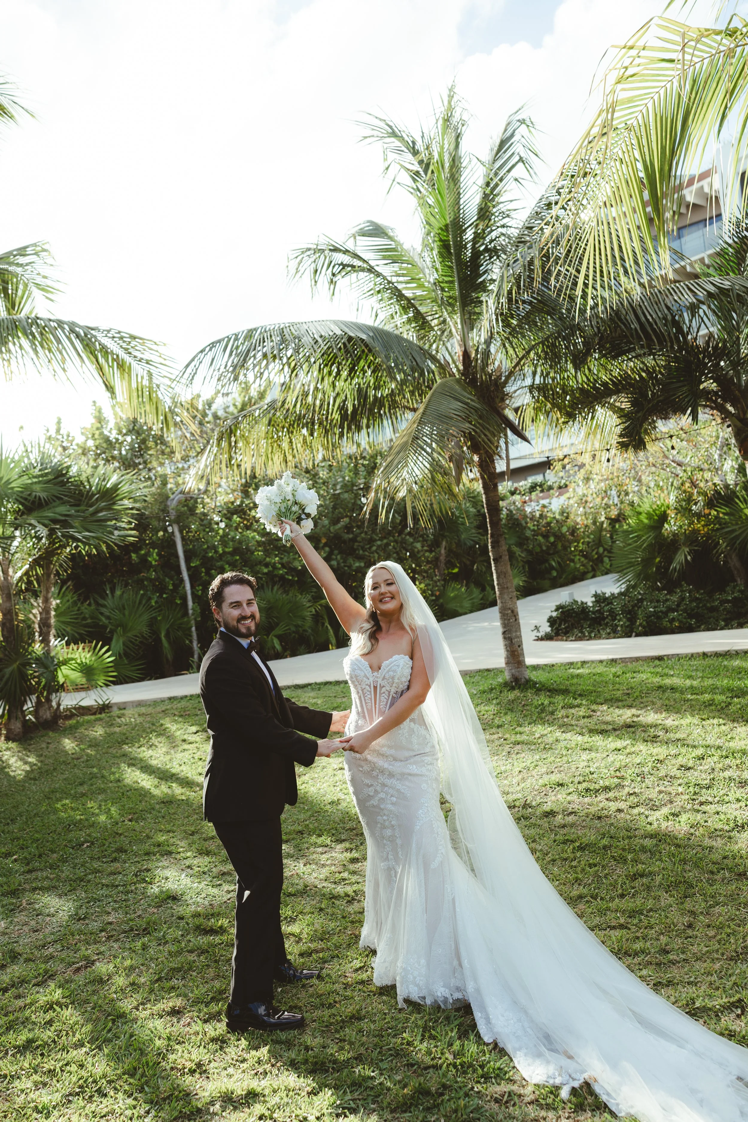 A photography of a couple after getting married on their wedding in the garden location in Atelier Playa Mujeres in Cancun