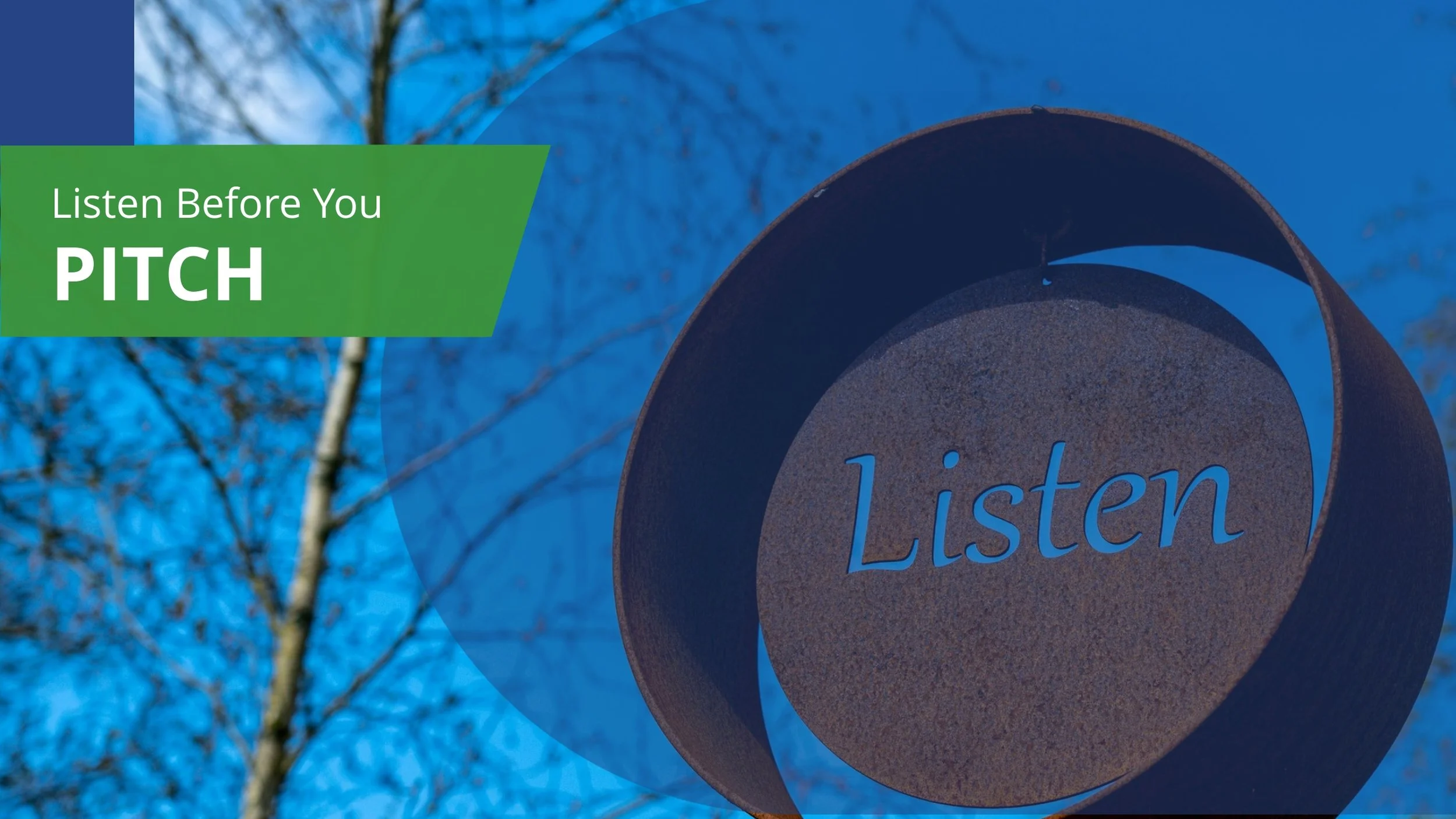 A metal bollard with the word 'Listen' inscribed on it, set against a background of leafless trees and a blue sky.