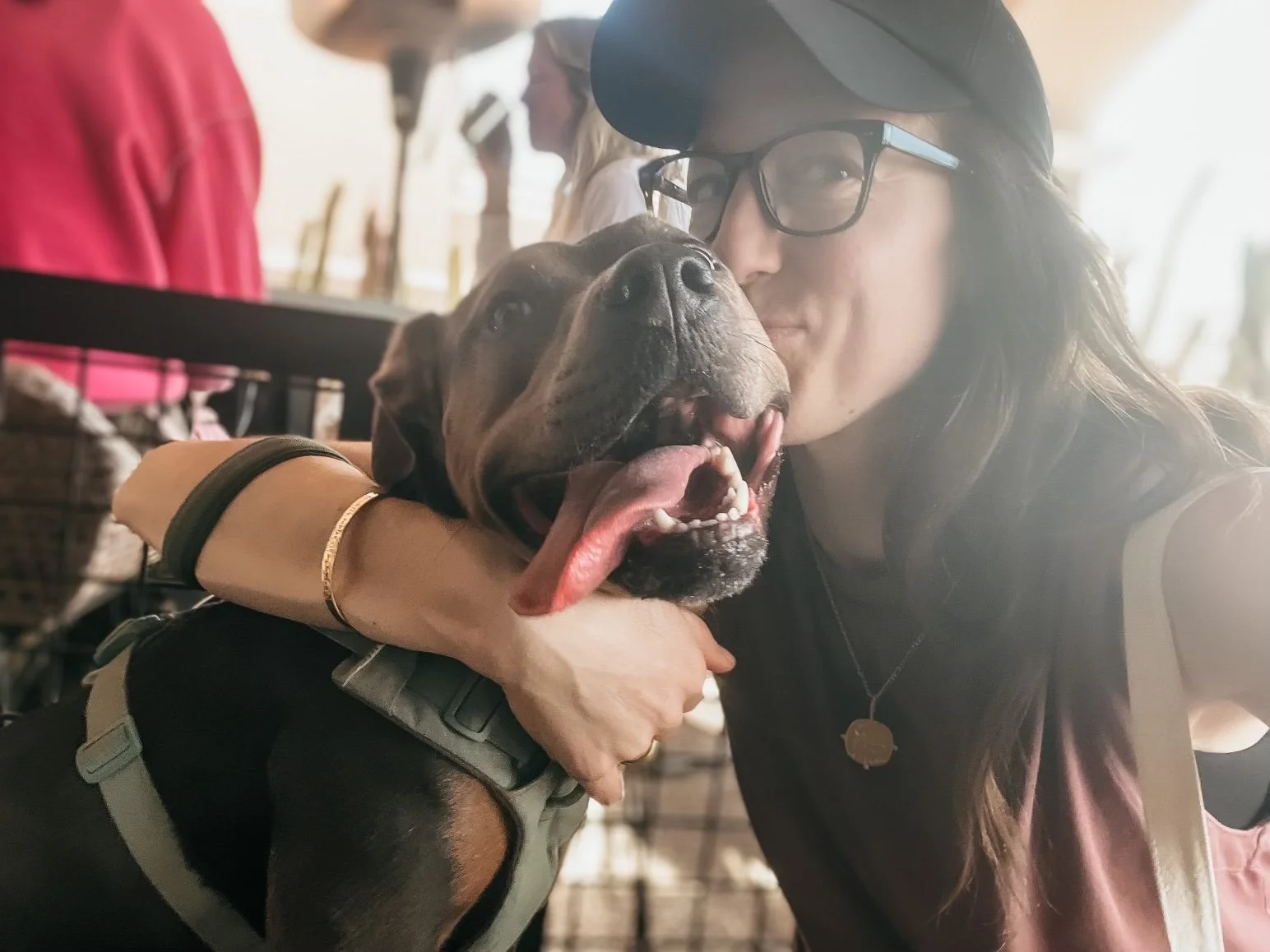 Dr. Elizabeth holding her dog Luna close, symbolizing grounded vitality and aligned momentum as she reflects on the energetic shift into the Fire Horse year.