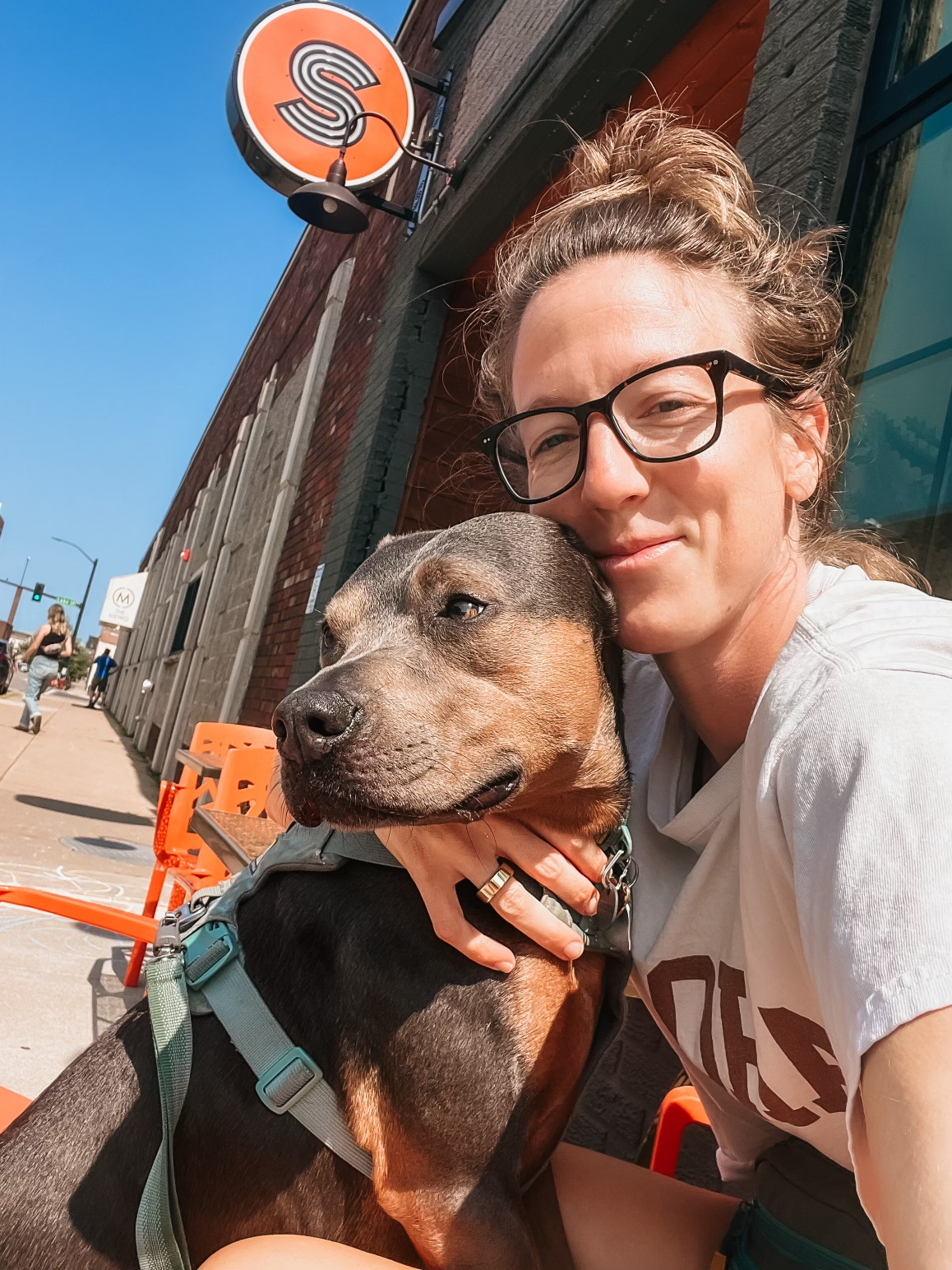 Dr. Elizabeth enjoying a sunny day outdoors with Luna, reflecting a whole-body approach to liver health, nourishment, and daily wellness.