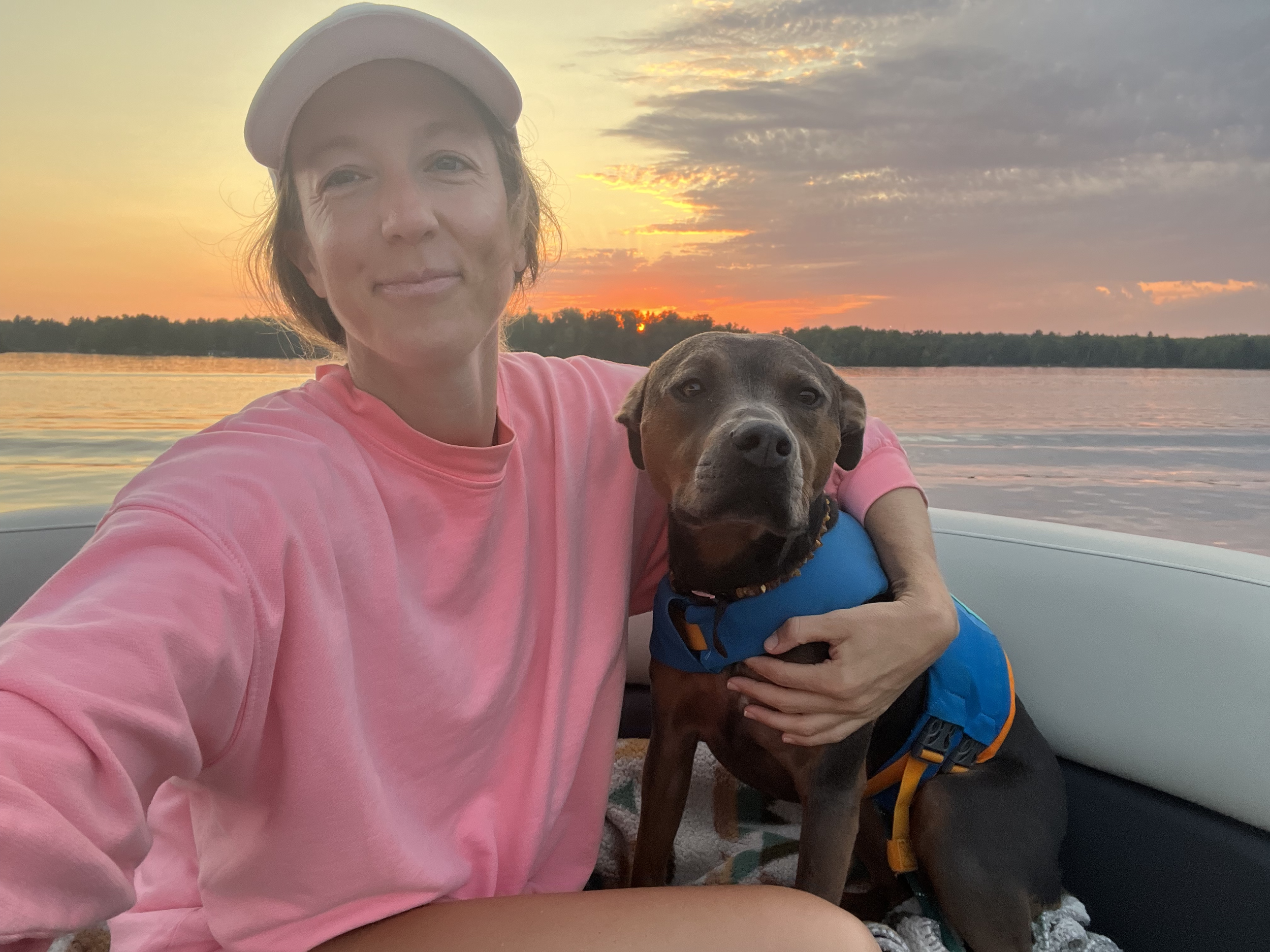 Dr. Elizabeth with her dog Luna outdoors at sunset, reflecting the daily rhythms, connection, and routines that support her nervous system.