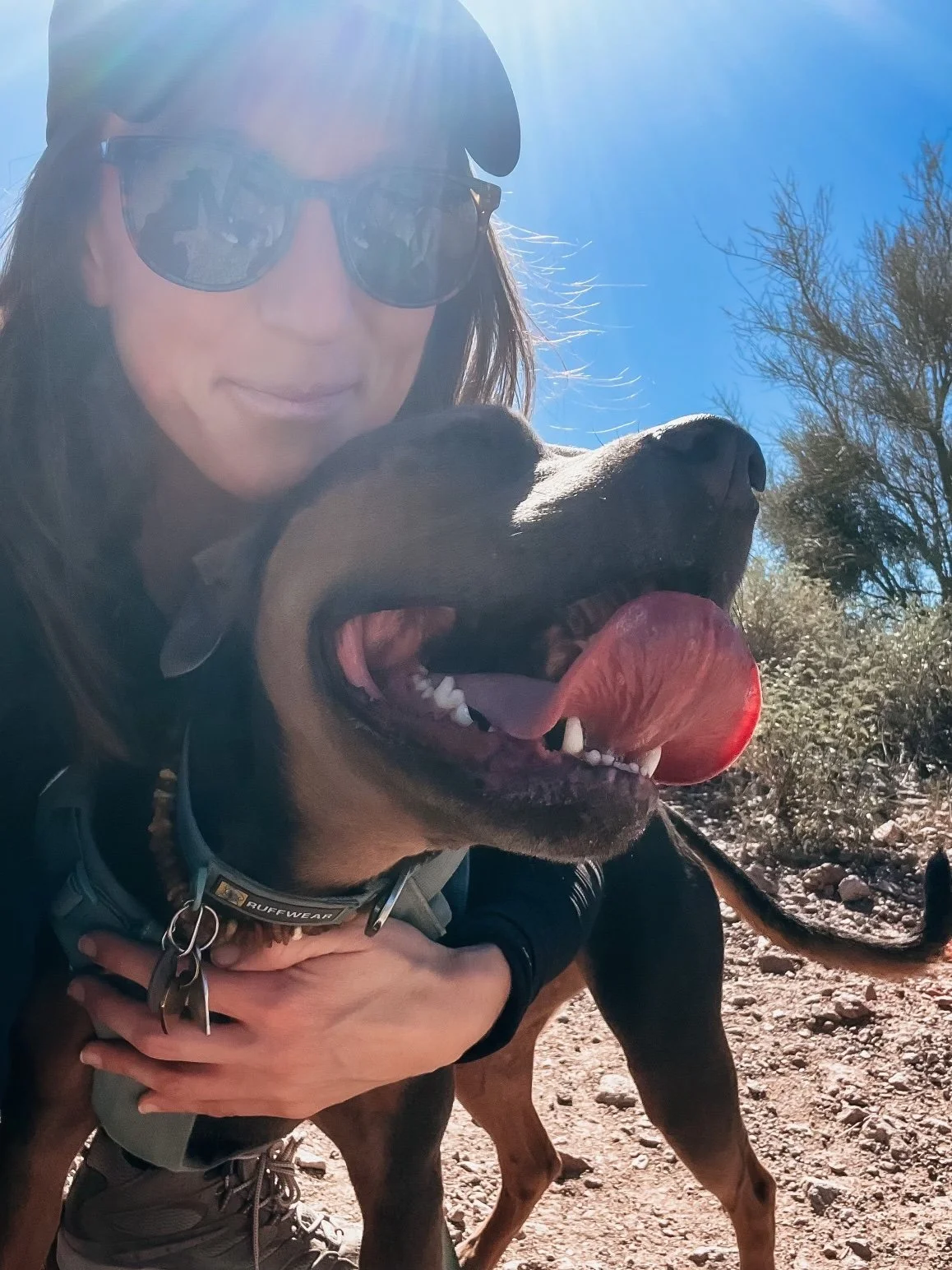 Dr. Elizabeth hiking with her dog Luna in the desert, representing grounded presence and energetic hygiene that supports nervous system healing.