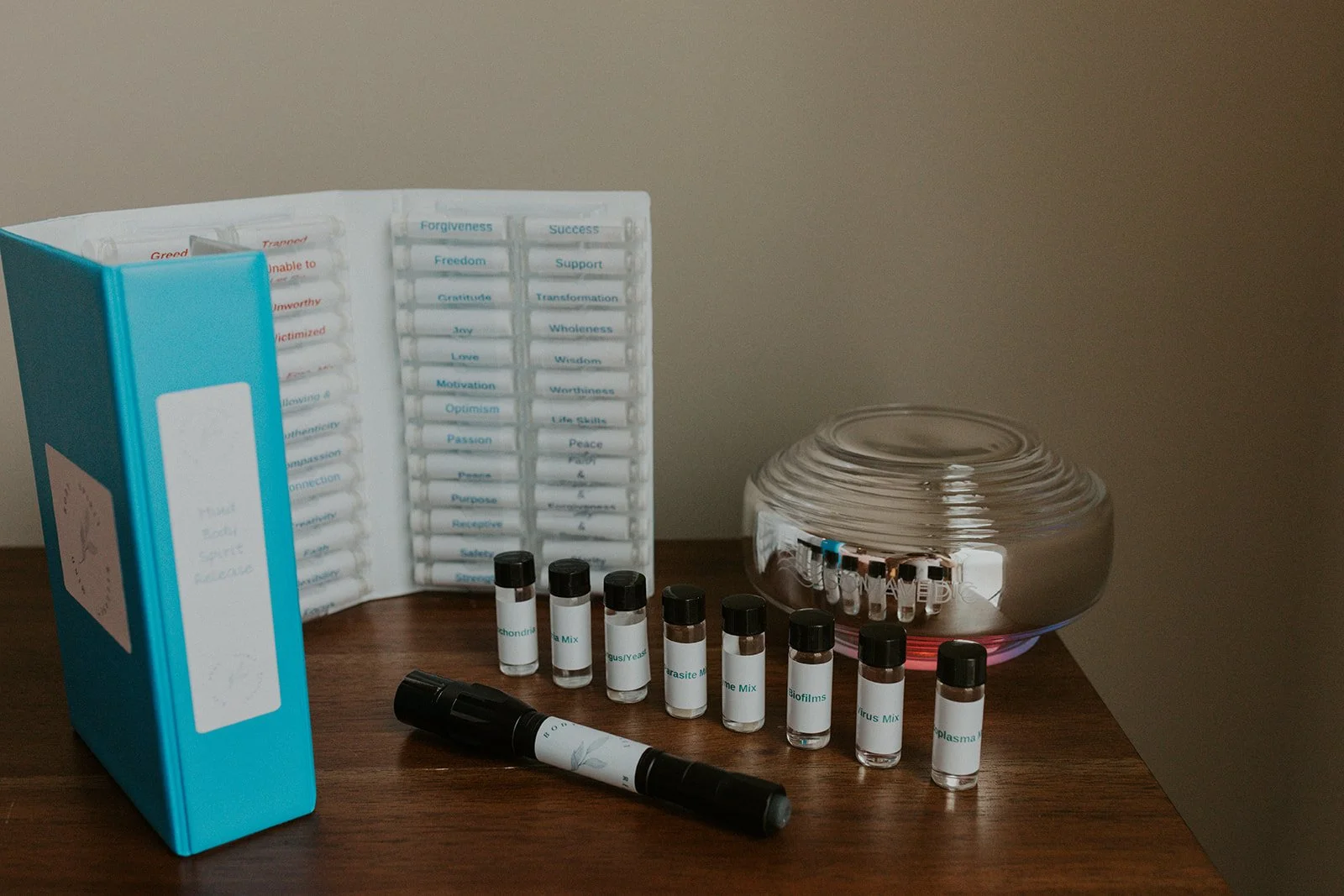 Flower essence vials and testing kit used in intuitive healing work, symbolizing subconscious belief support and emotional integration.