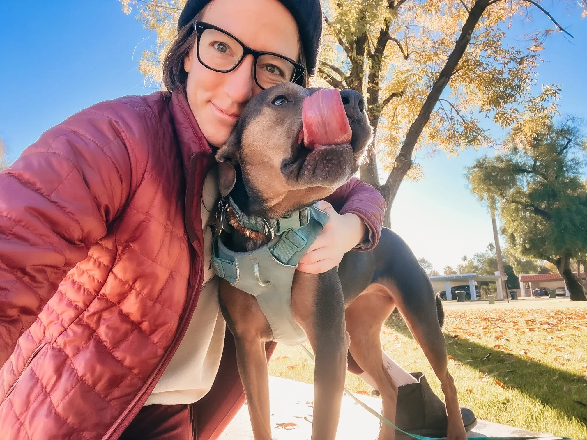 Dr. Elizabeth with her dog Luna outdoors, symbolizing safety, grounded presence, nervous system regulation, and compassionate support.
