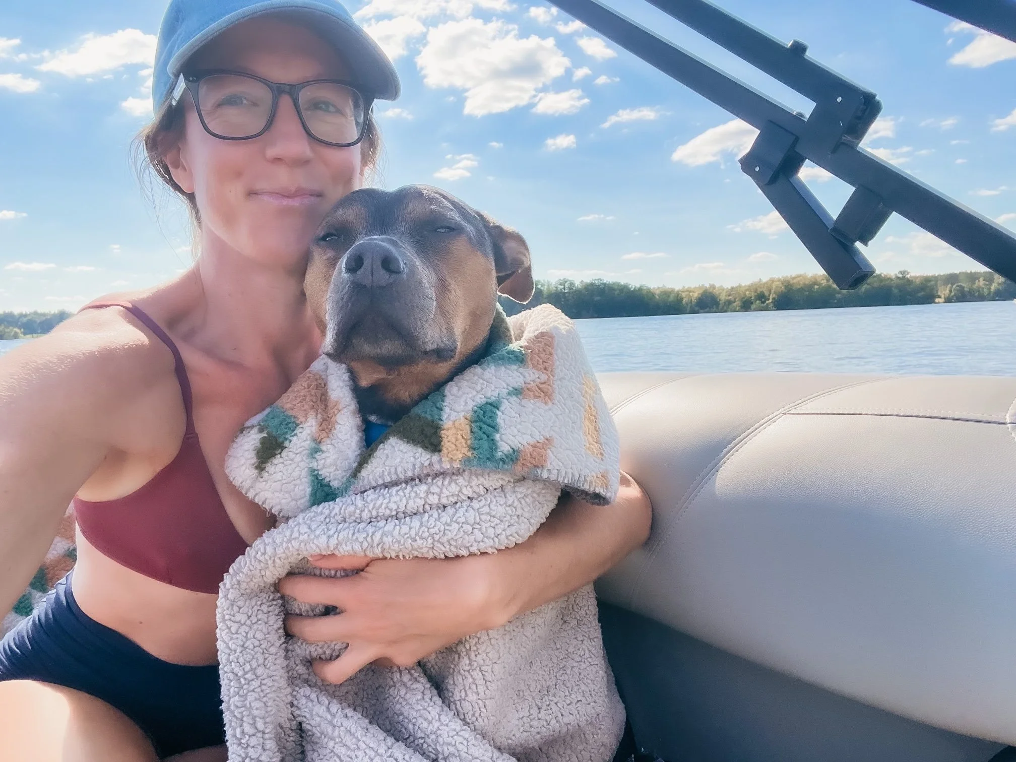 Dr. Elizabeth embracing Luna outdoors, representing steadiness, support, and nervous system regulation.