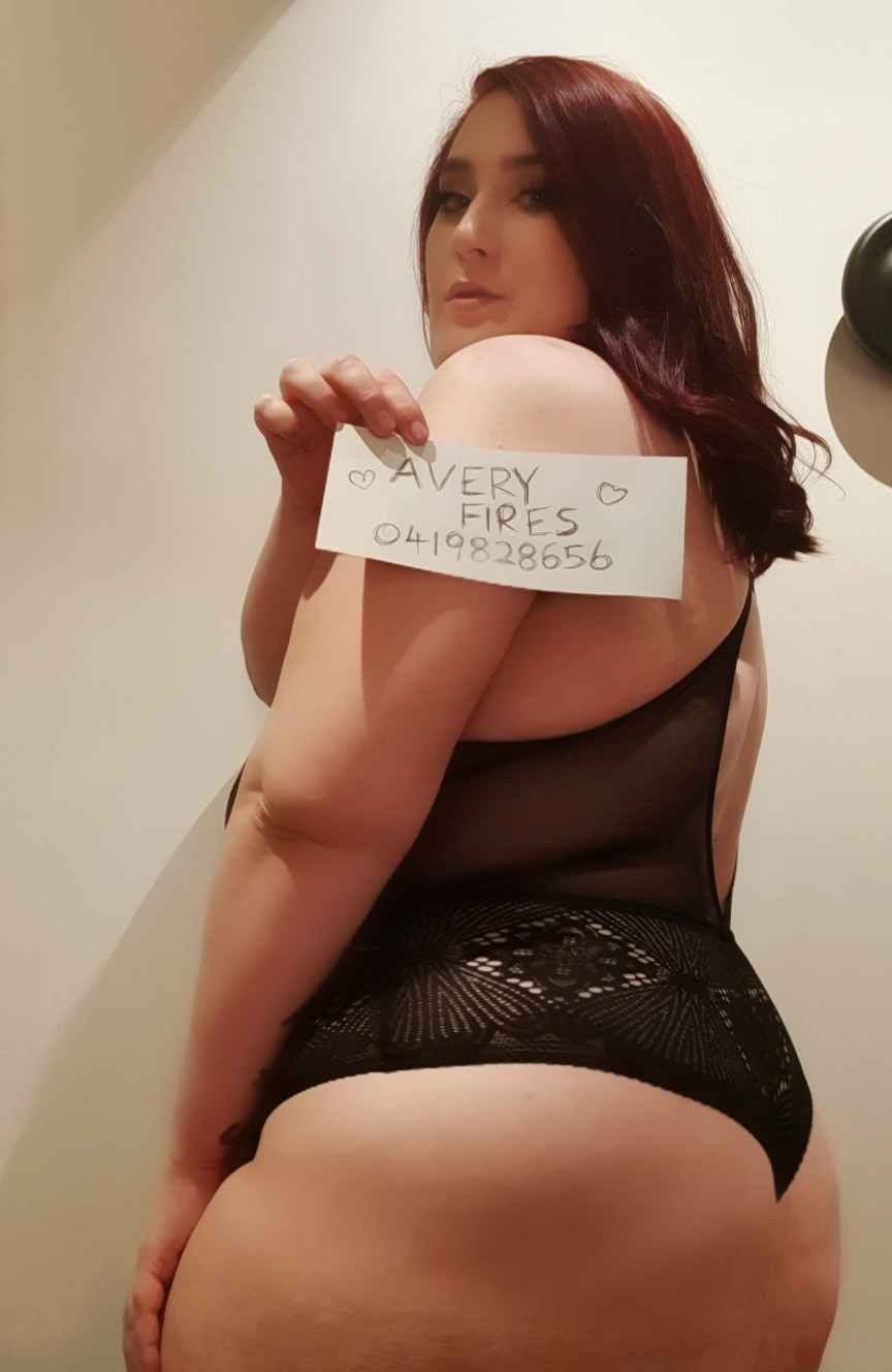Avery Fires wearing a black lace bodysuit holding a verification image that says "avery fires 0419828656"