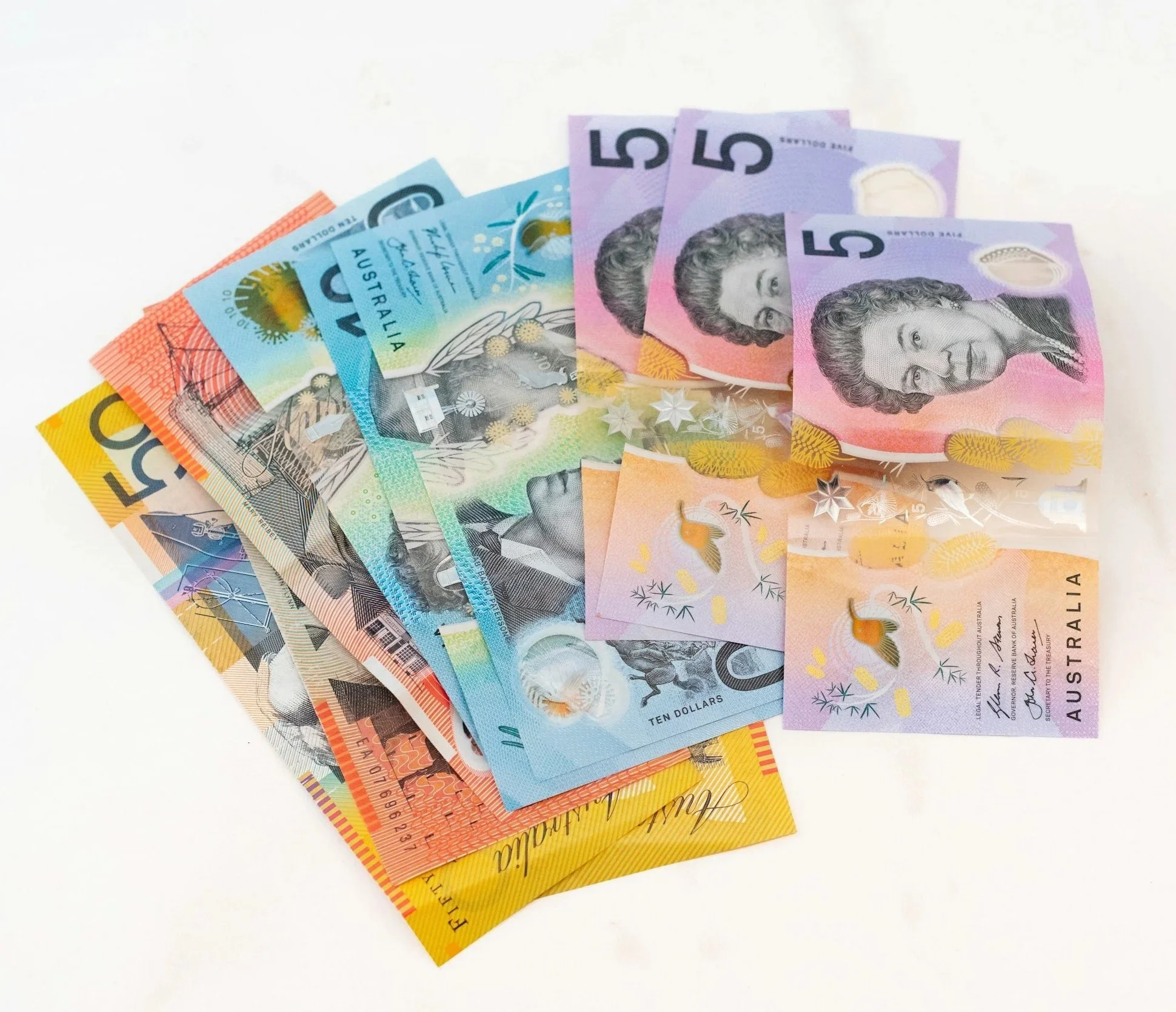 Australian money with a whilte background spread into a fan