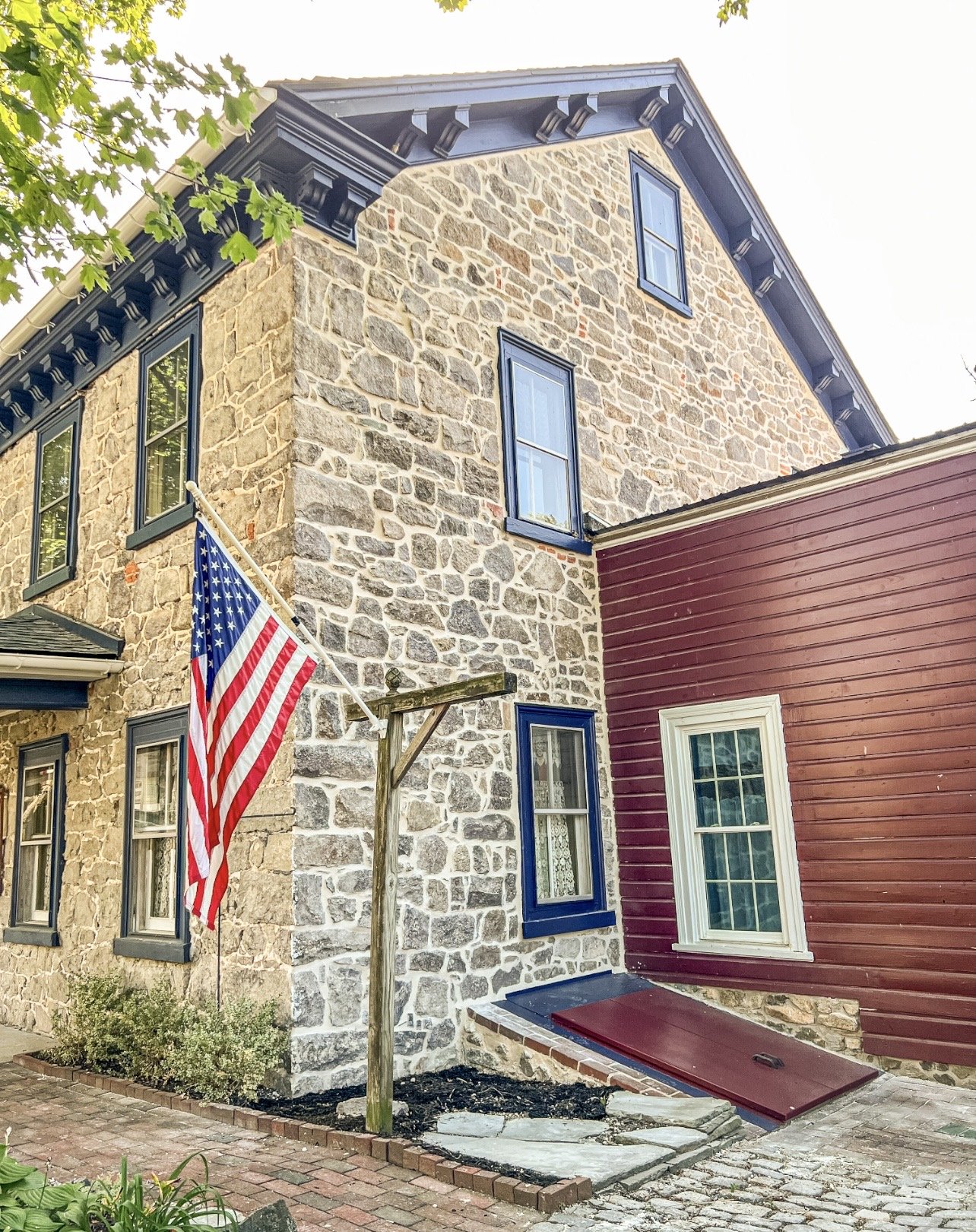 Repointed stone exterior, painted window and gable trim