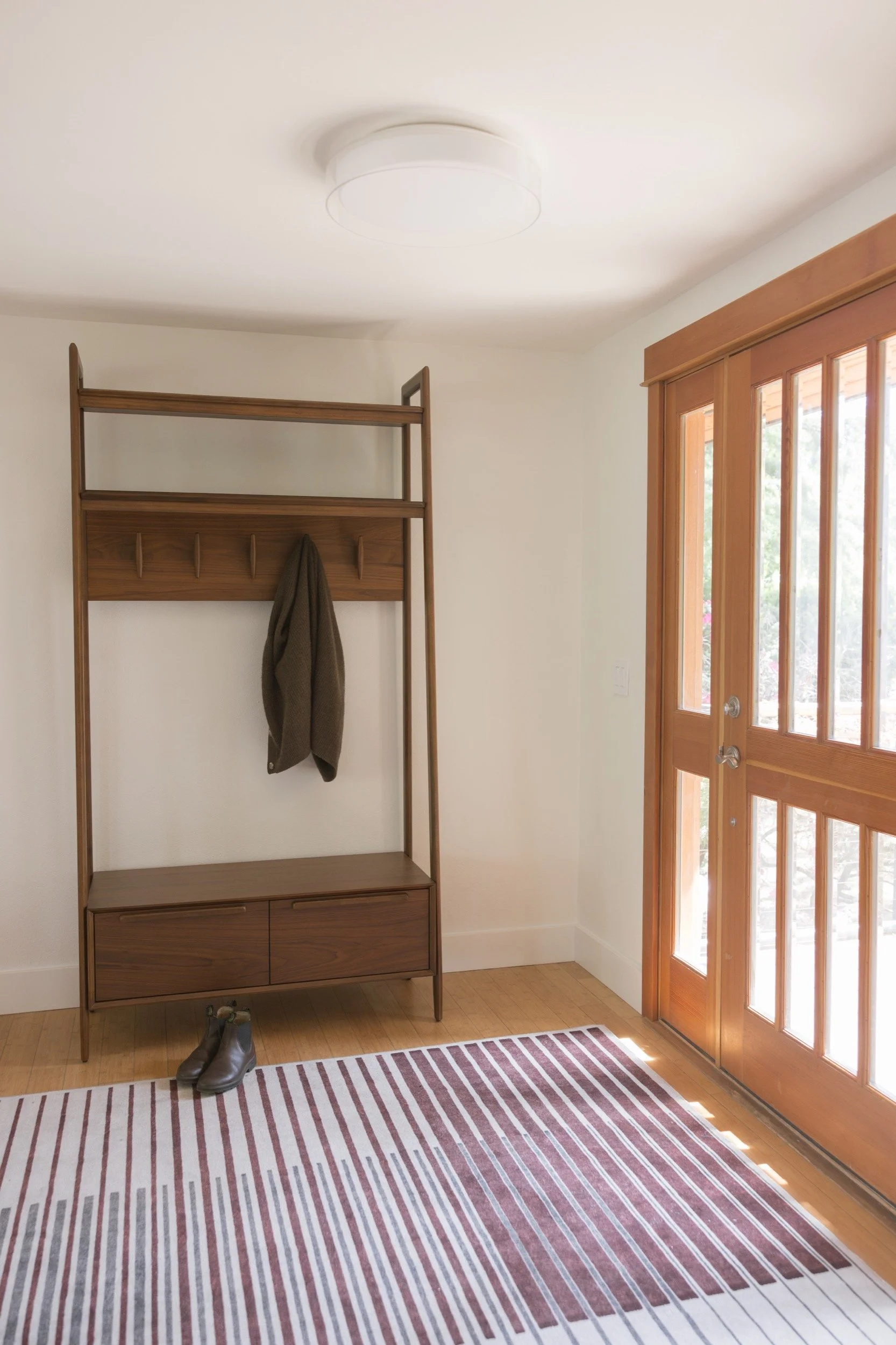 Entry nook with a built-in bench and coat hooks in a Hood River home