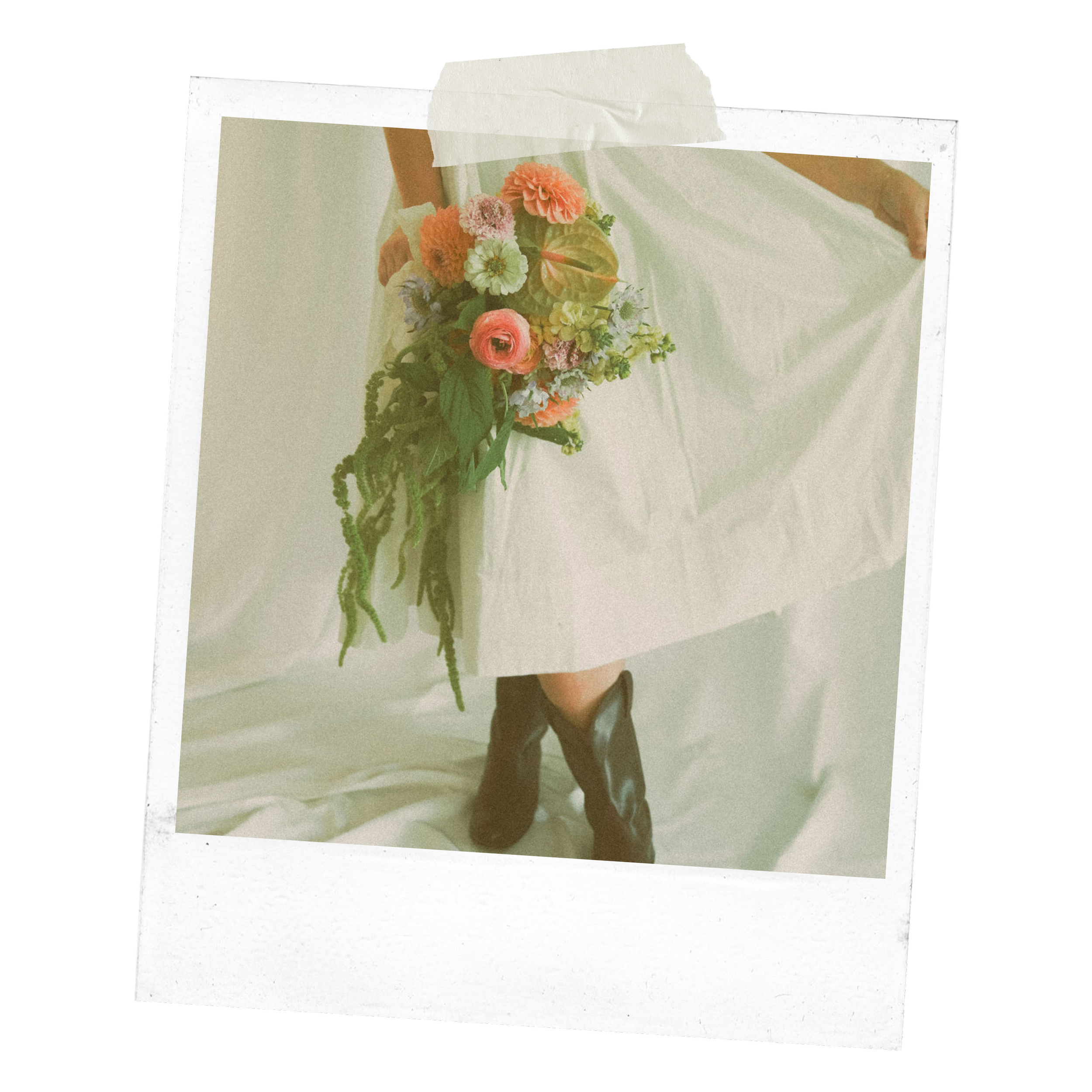 Person in white dress holding a bouquet of colorful flowers, wearing red boots.