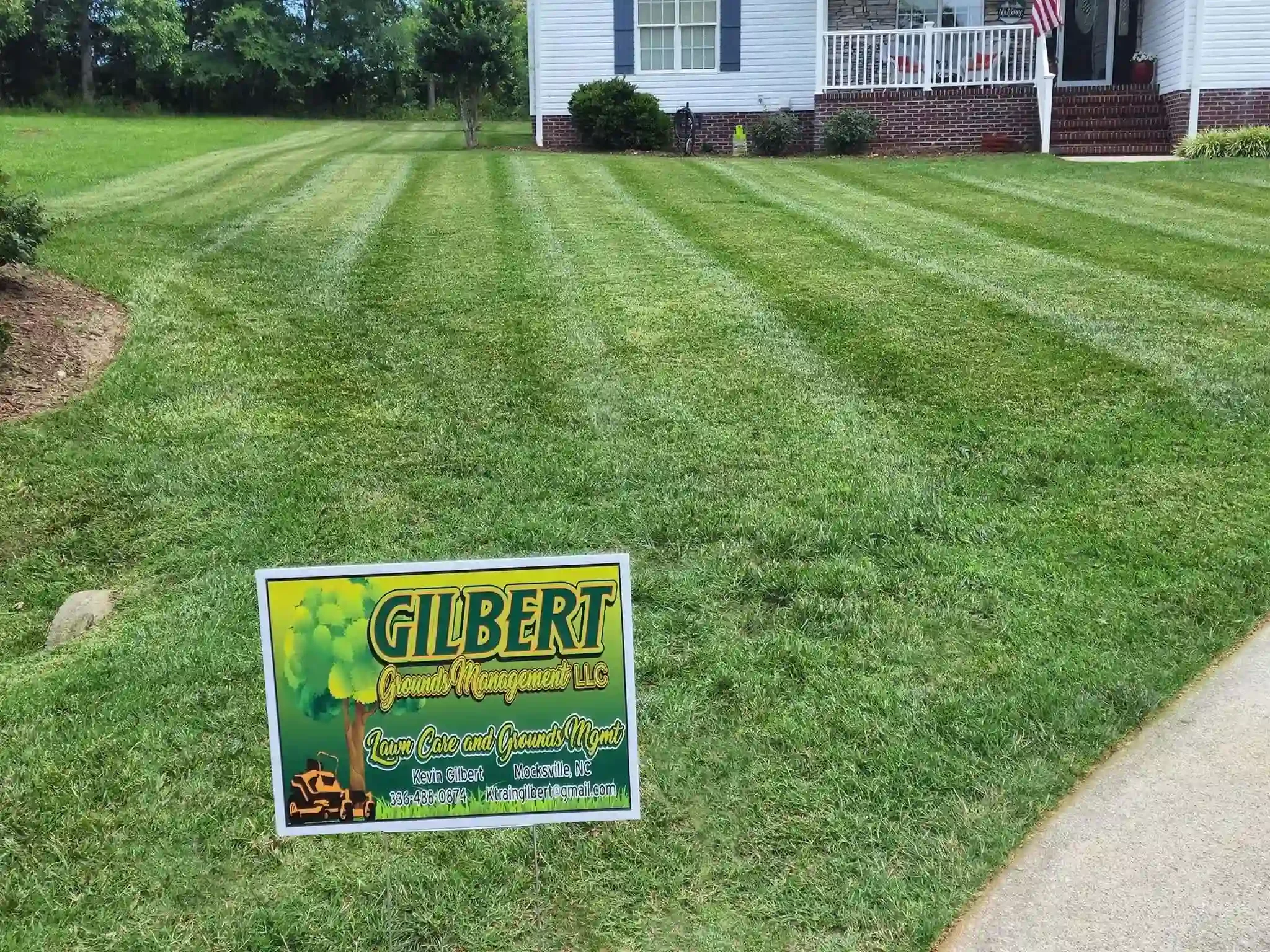 Expert lawn maintenance and mowing services in Clemmons NC. Front yard featuring freshly cut grass with straight stripes.
