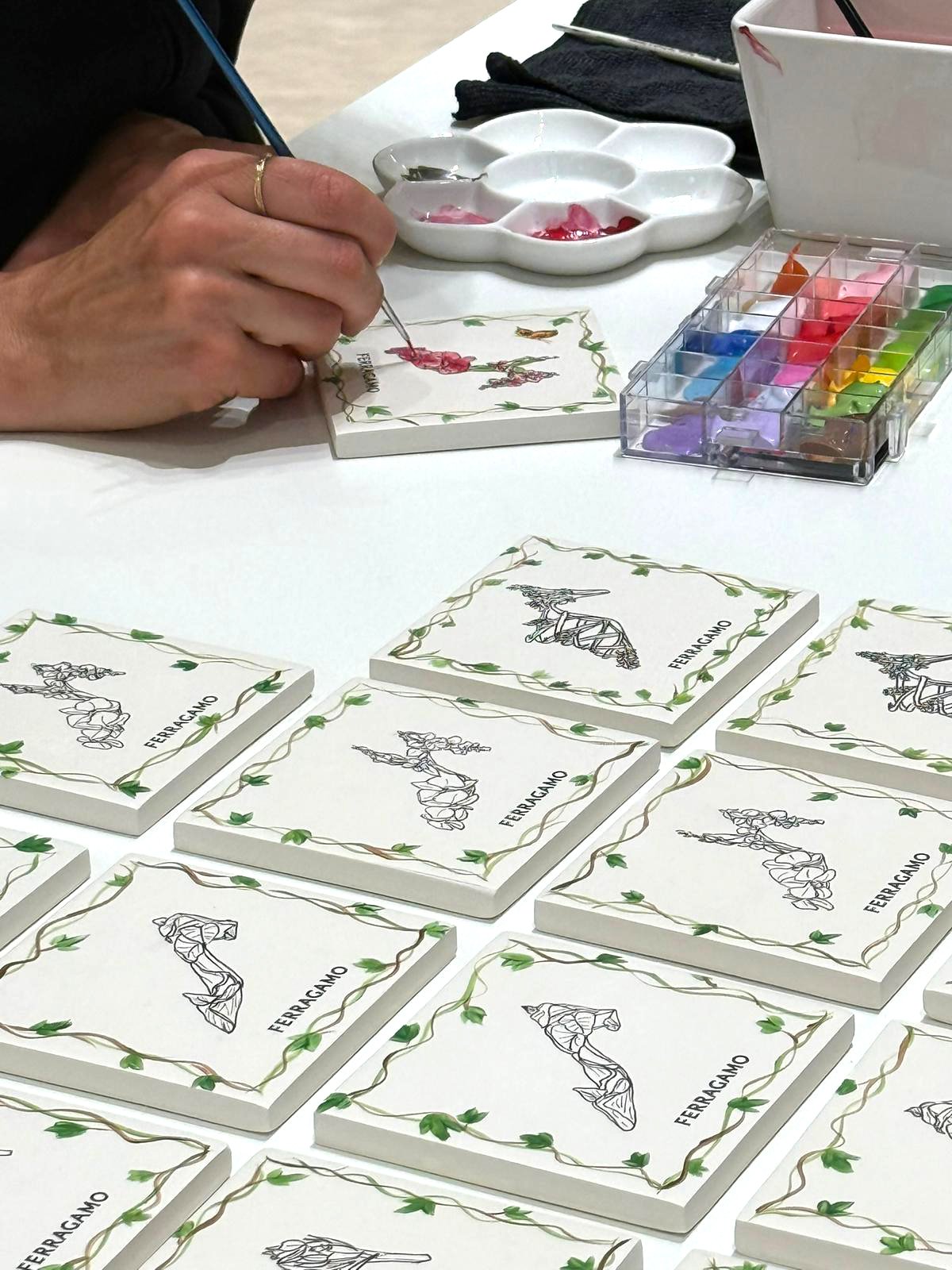 Painting a ceramic tile for Ferragamo activation in Athens