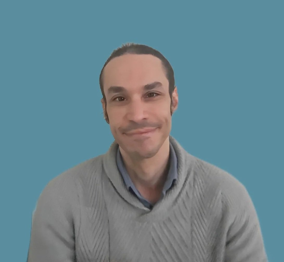 An adult  male sitting on a sofa