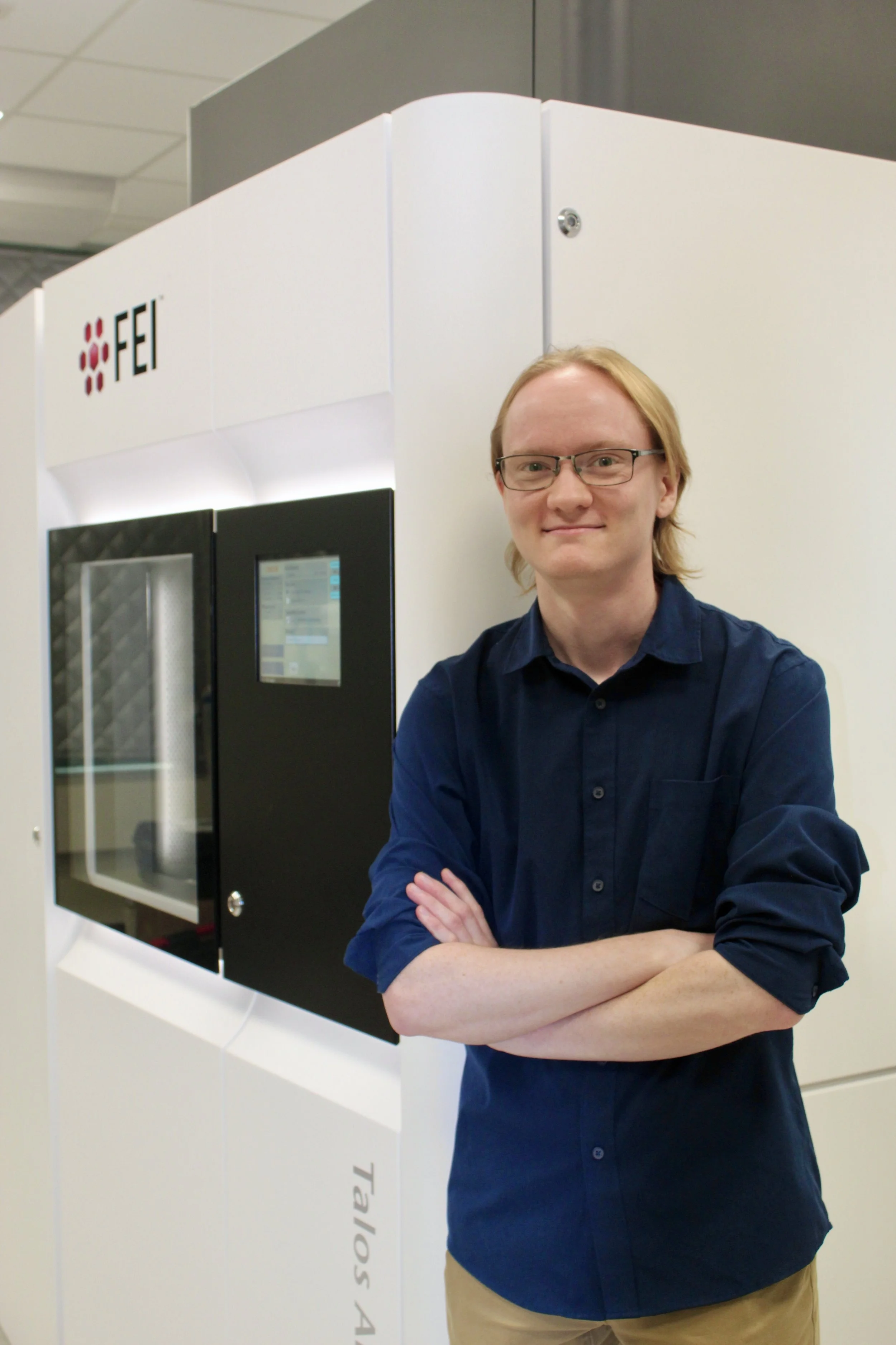 man in front of scientific instrument