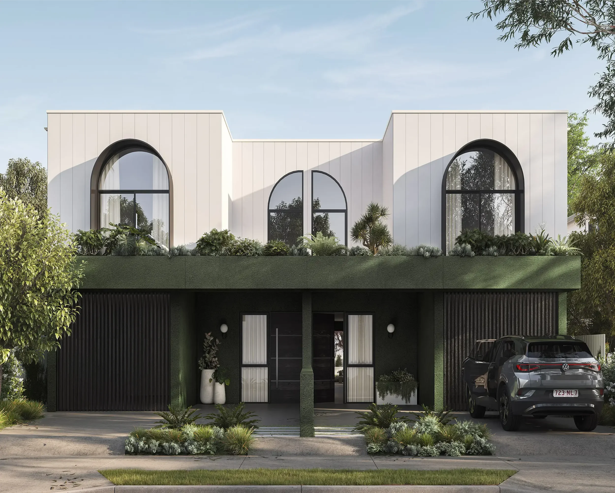 Modern white house with large arched windows, greenery in front, and a black car parked in the driveway.