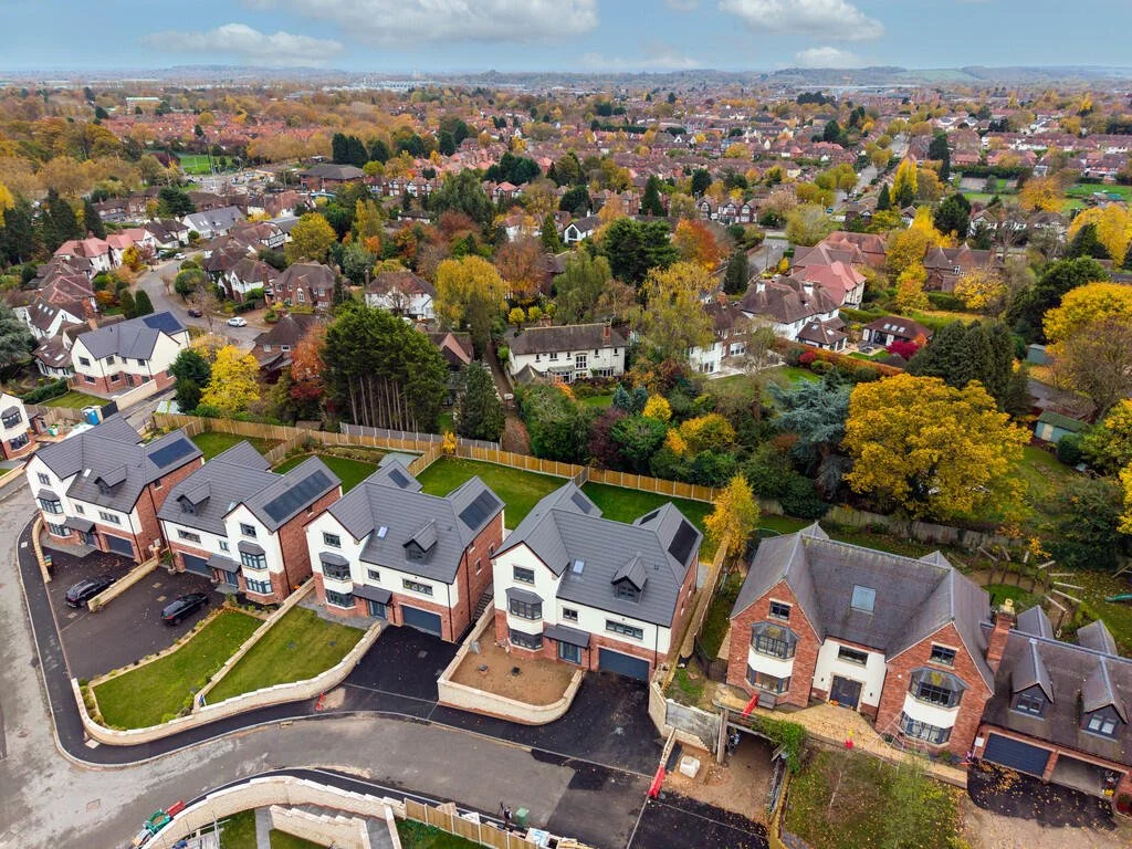 Merritt Estates. Aerial view of a suburban neighbourhood with new construction houses and mature trees with autumn foliage.