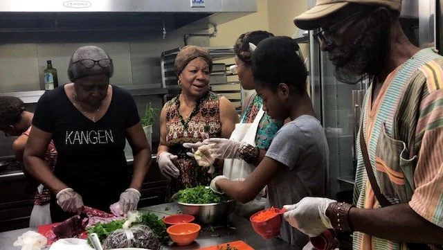 Participants at an FFM cooking and nutrition class learning about cultural cuisine through A Taste of African Heritage program content.