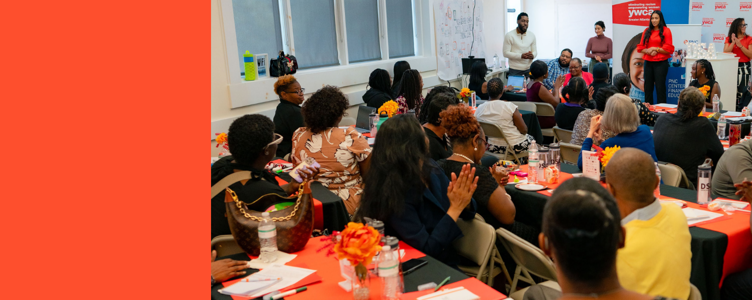 Group of diverse women sitting outdoors attending an event, some wearing masks and glasses, with trees and parked cars in the background.