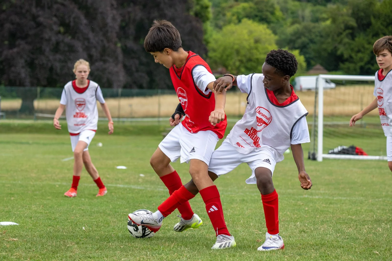 A player tackling another player in a football match.