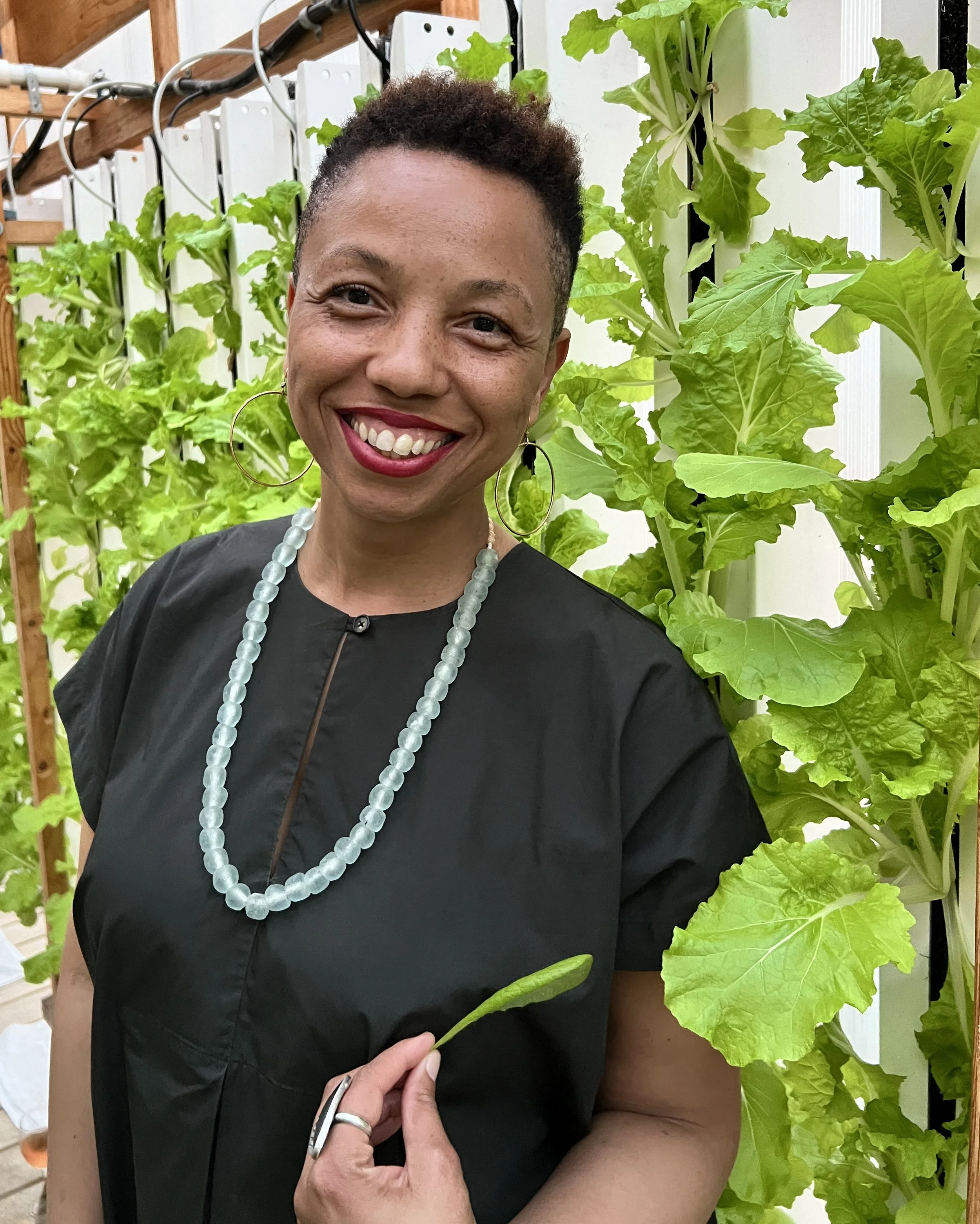 Photo of Qiana Mickie in front of plants