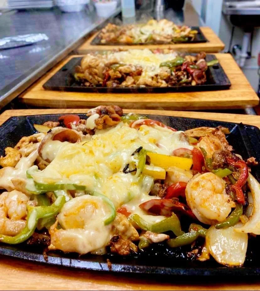 Three plated meals with steaming coming off of them.