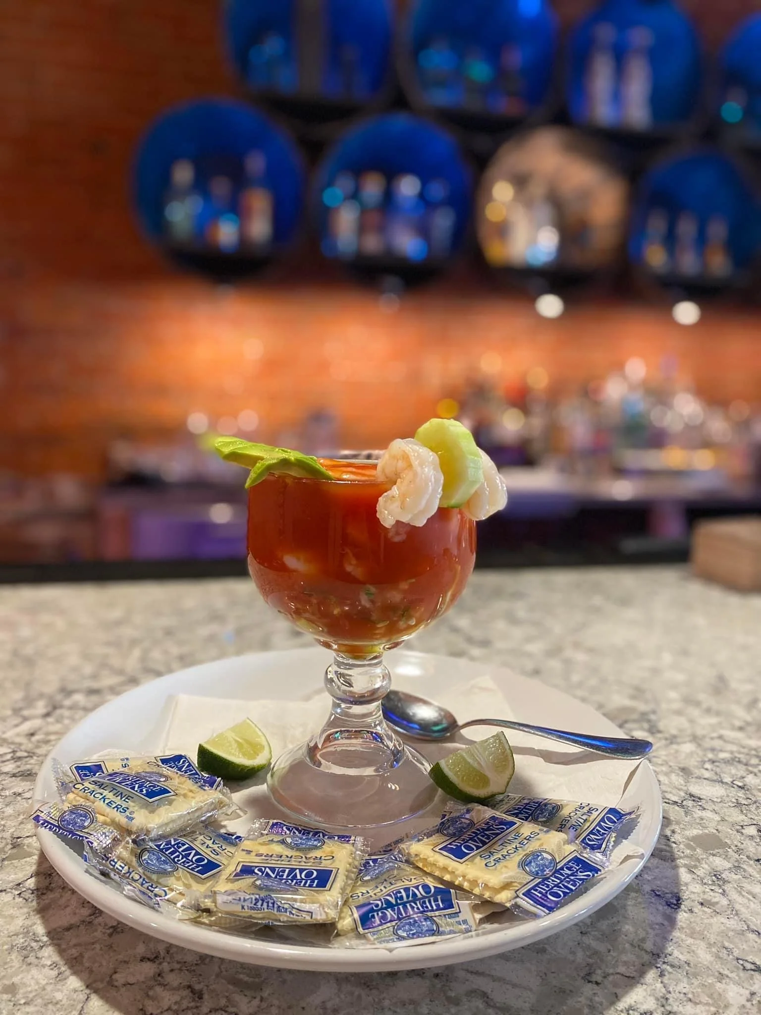 An made drink in placed on the bar counter.