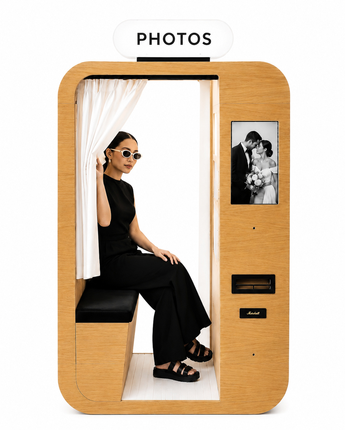 Family capturing memories together, huddled close and smiling in a photobooth.