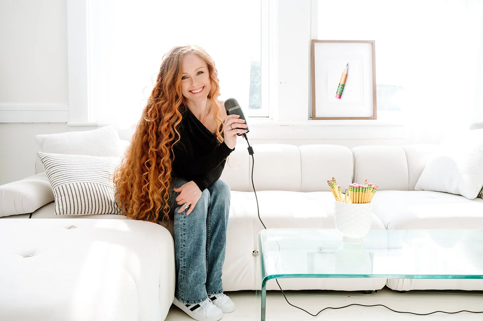 Katie Azevedo holding a podcast microphone