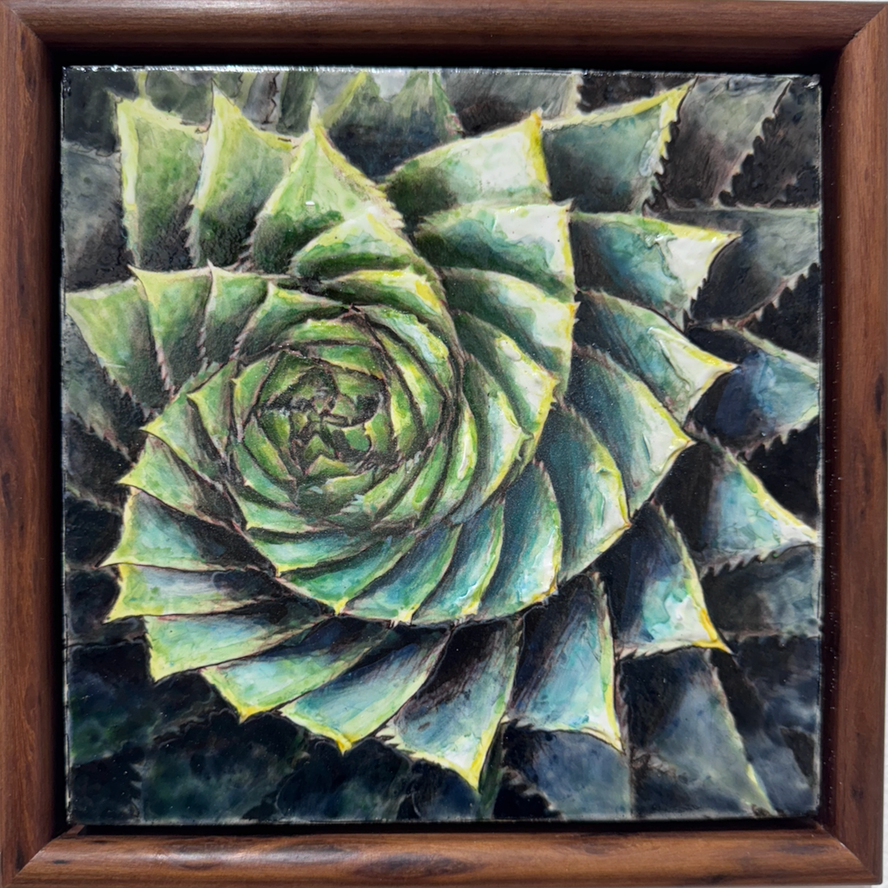 Enamel artwork of an aloe plant in spiralling layers of blue and green