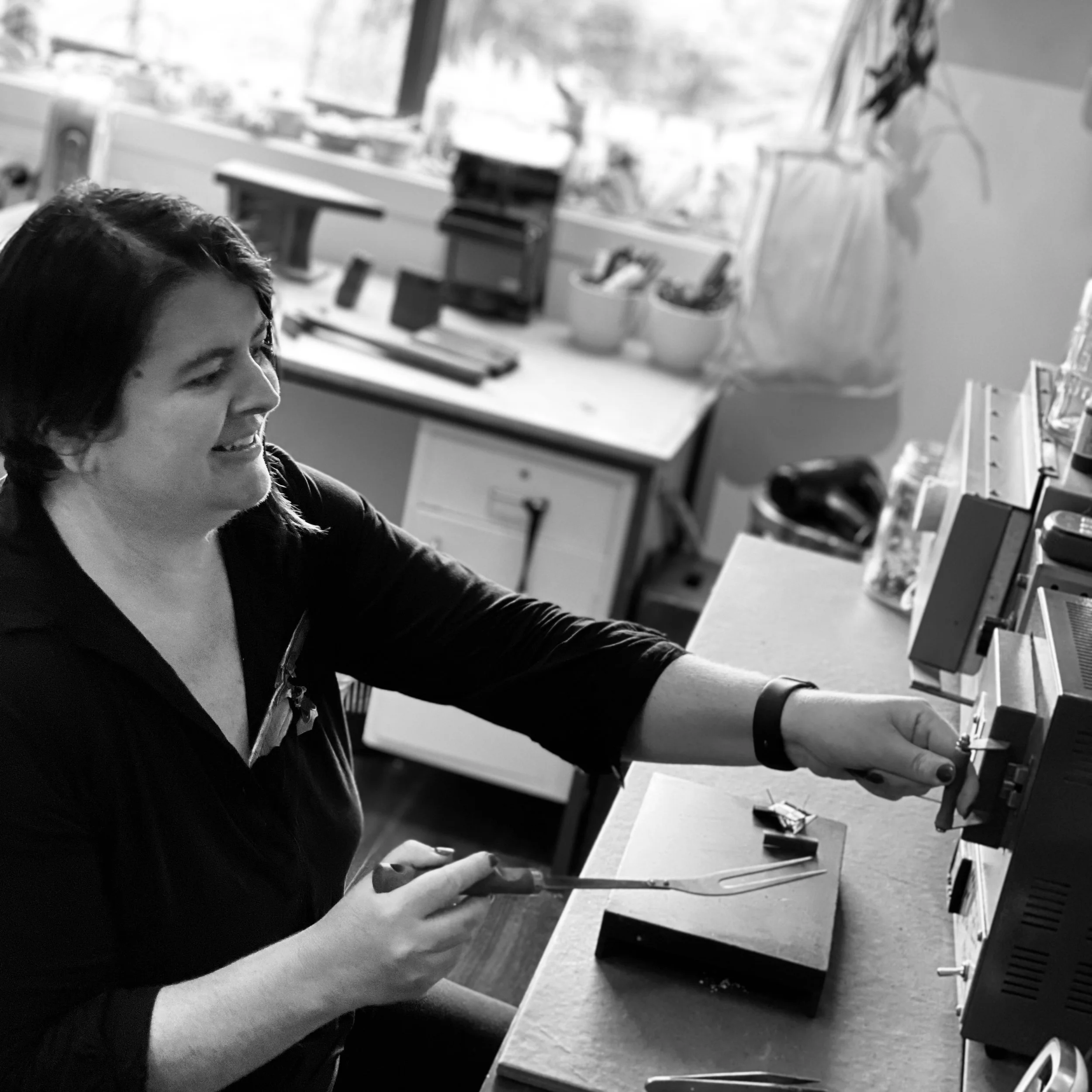 CLeed firing an enamel piece in her kiln.