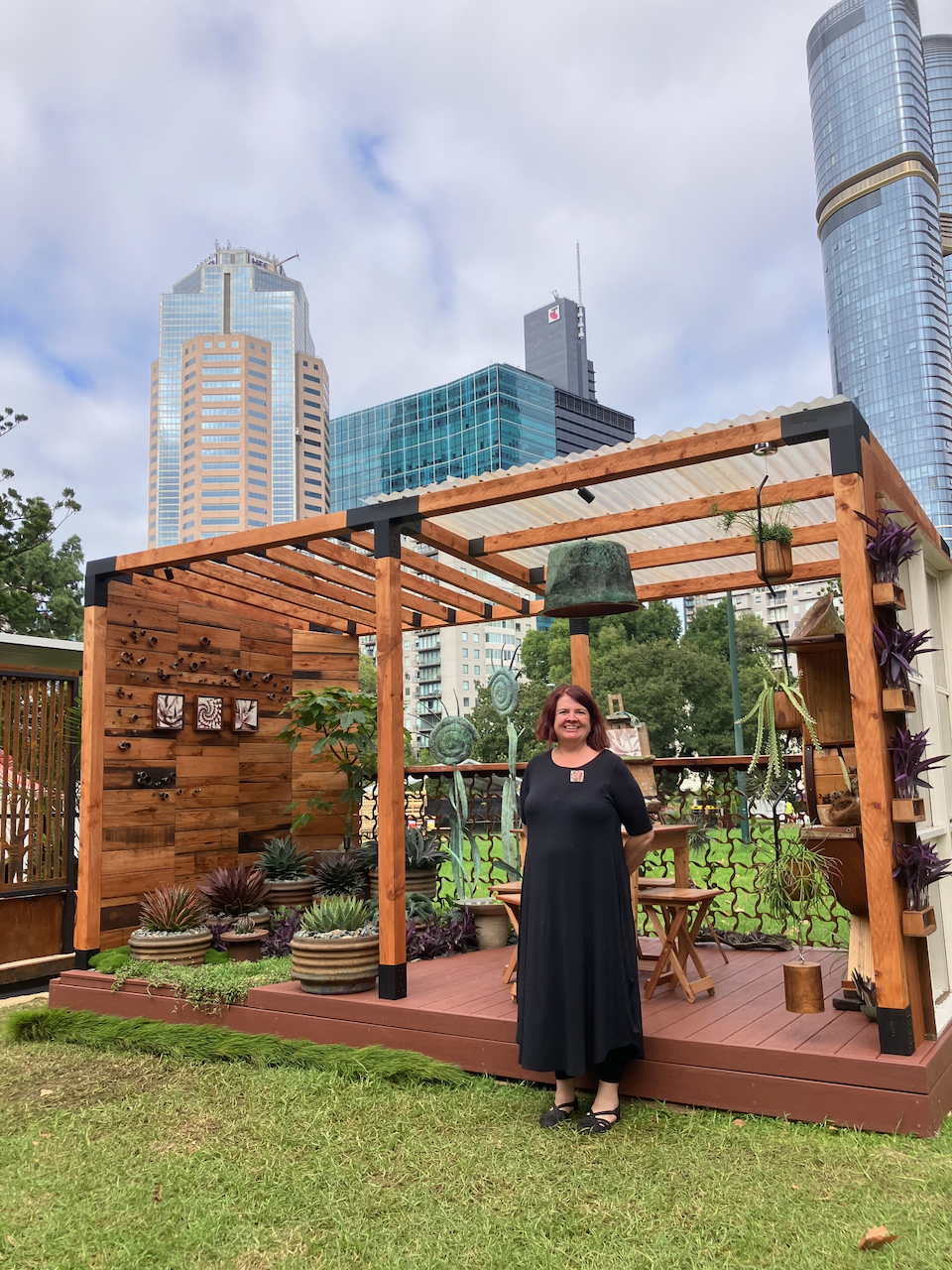 CLeed at the Melbourne International Flower and Garden Show in March 2025. She is in front of her award winning balcony garden: The Artists' Garden