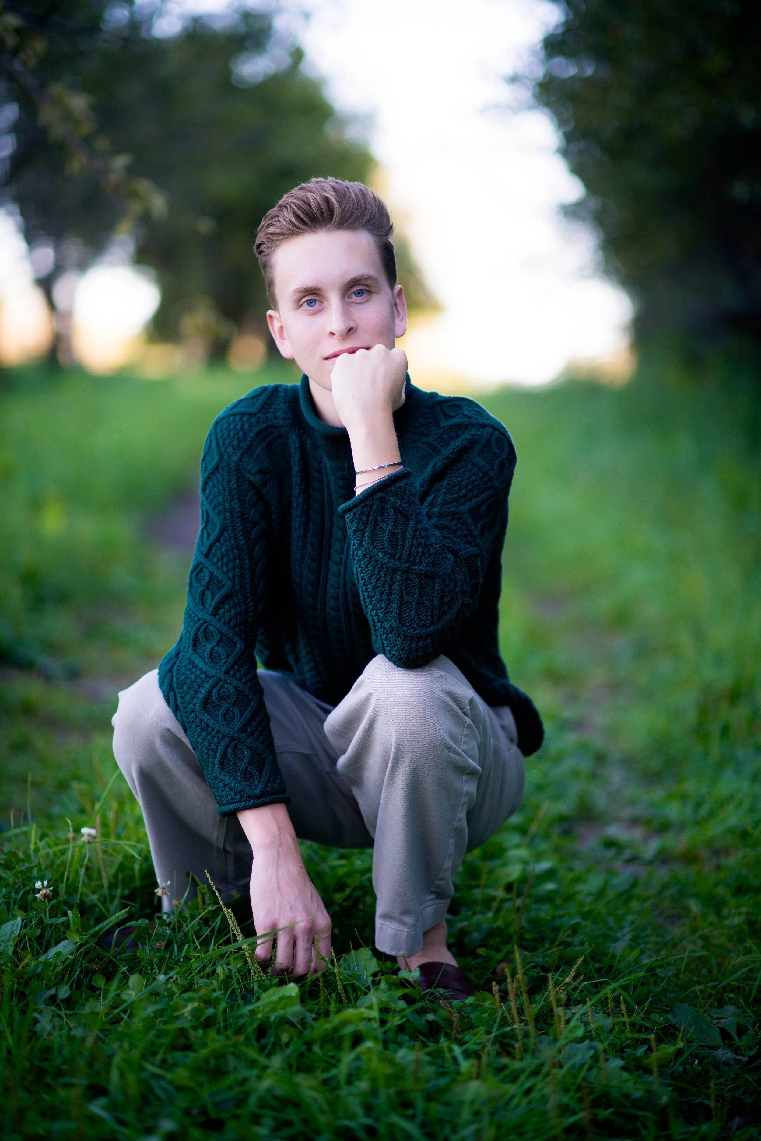 Senior guy squatting in field.jpg