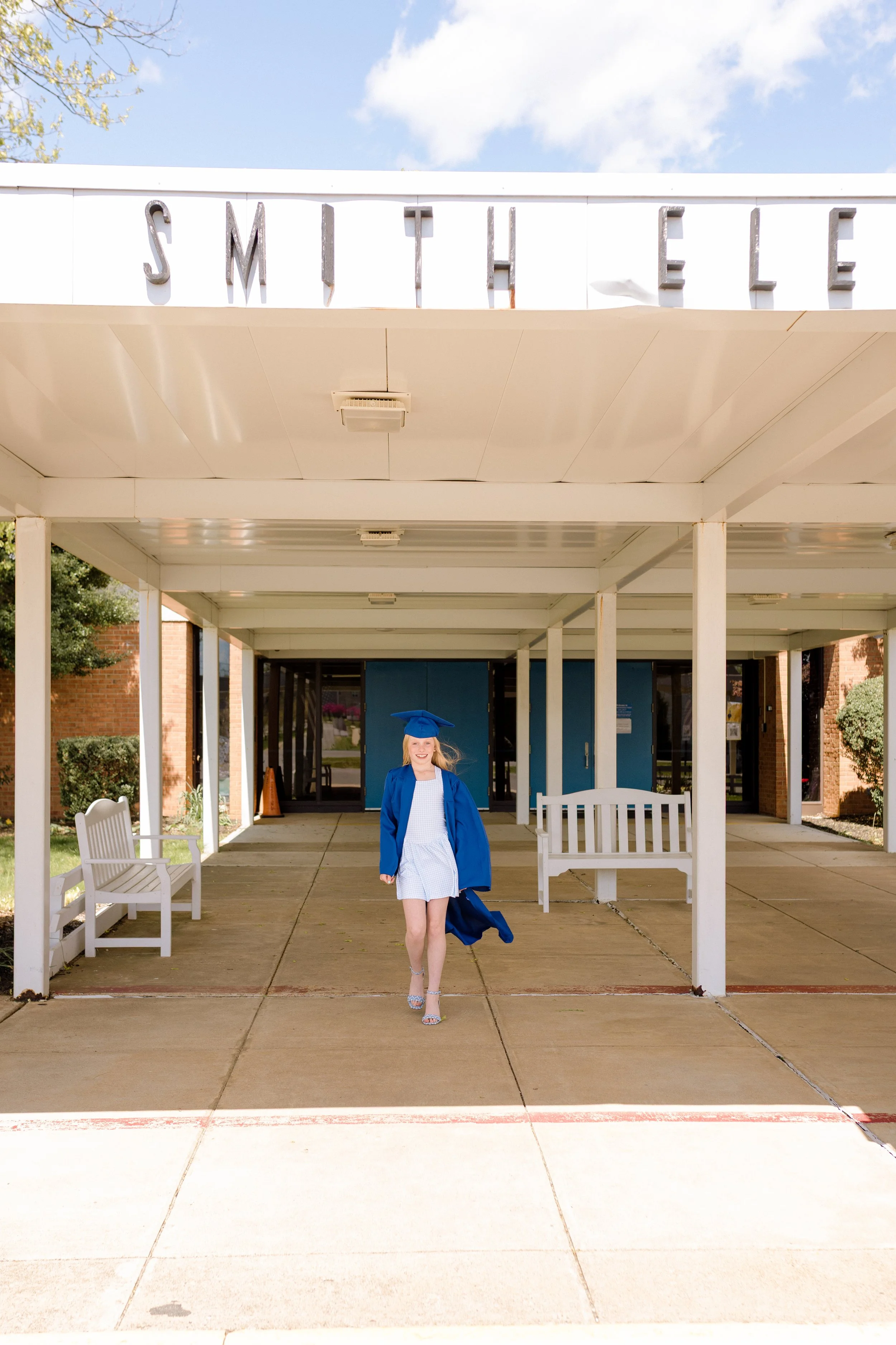 Fifth grade girl walking away from PB Smith Elementary for a graduation portrait.