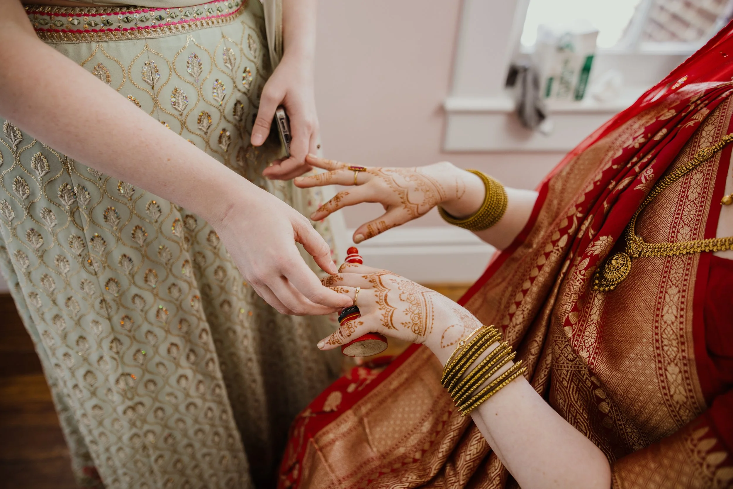 Close-up of the bride’s henna-covered hands and traditional wedding details during getting ready at Raspberry Plain Manor in Virginia.
