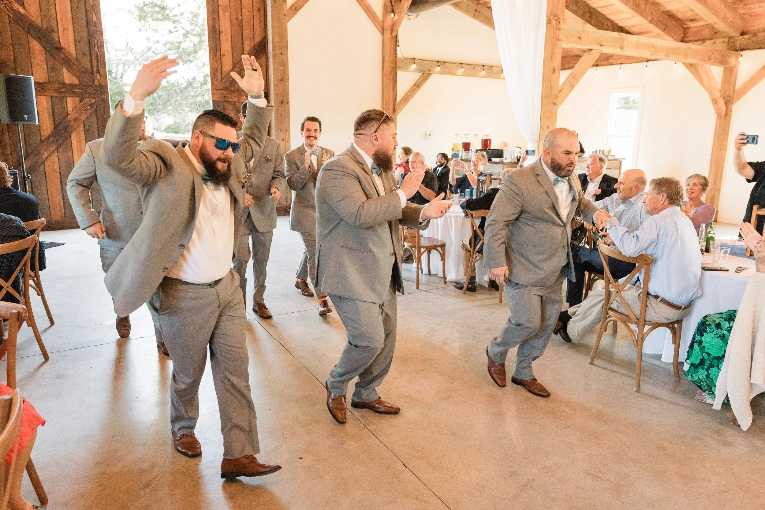 caitlin-johnathan-persimmon-creek-barn-groomsmen-reception-entrance.jpg