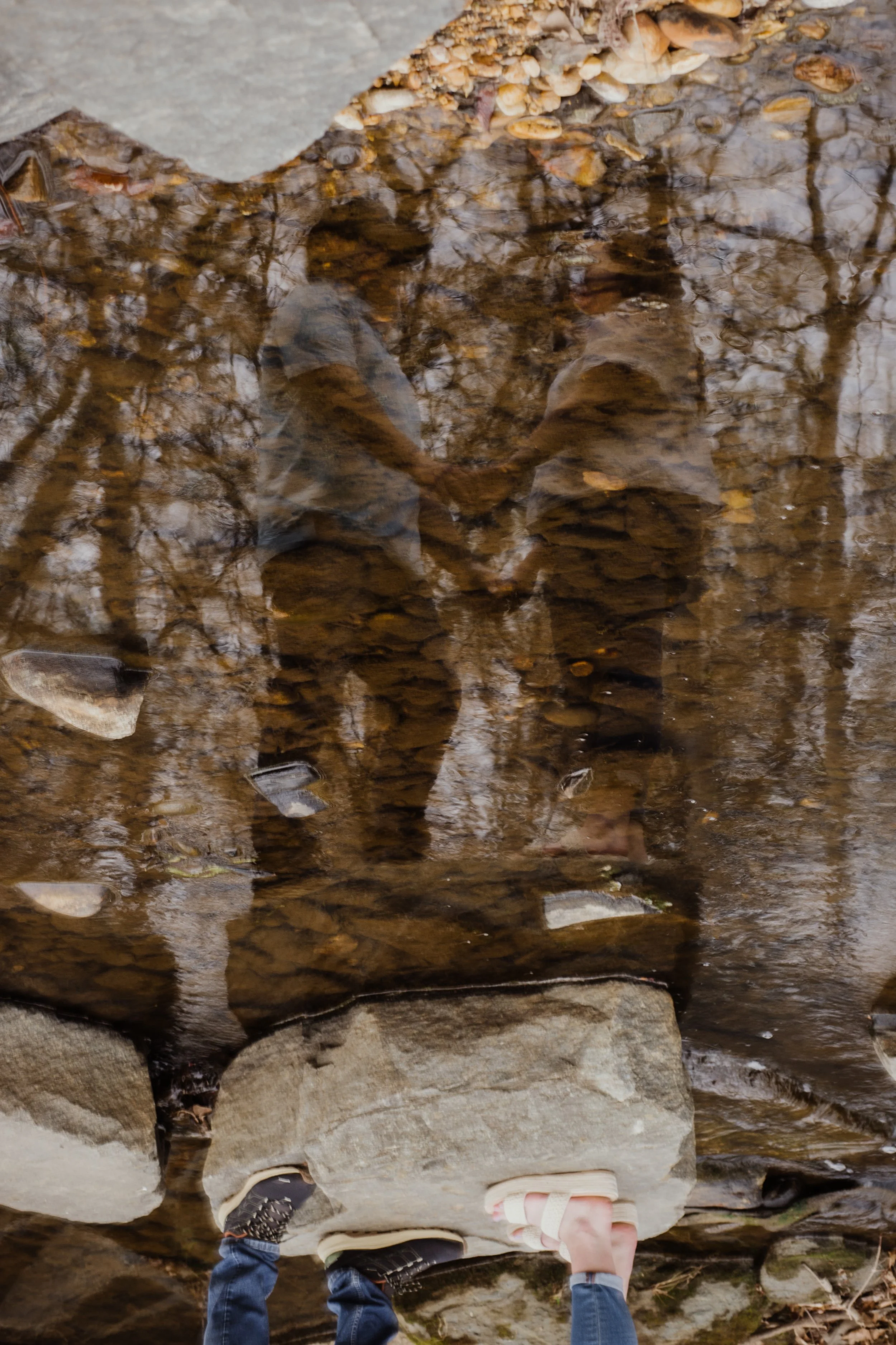 Creative reflection photo of engaged couple holding hands during a Northern Virginia engagement session.