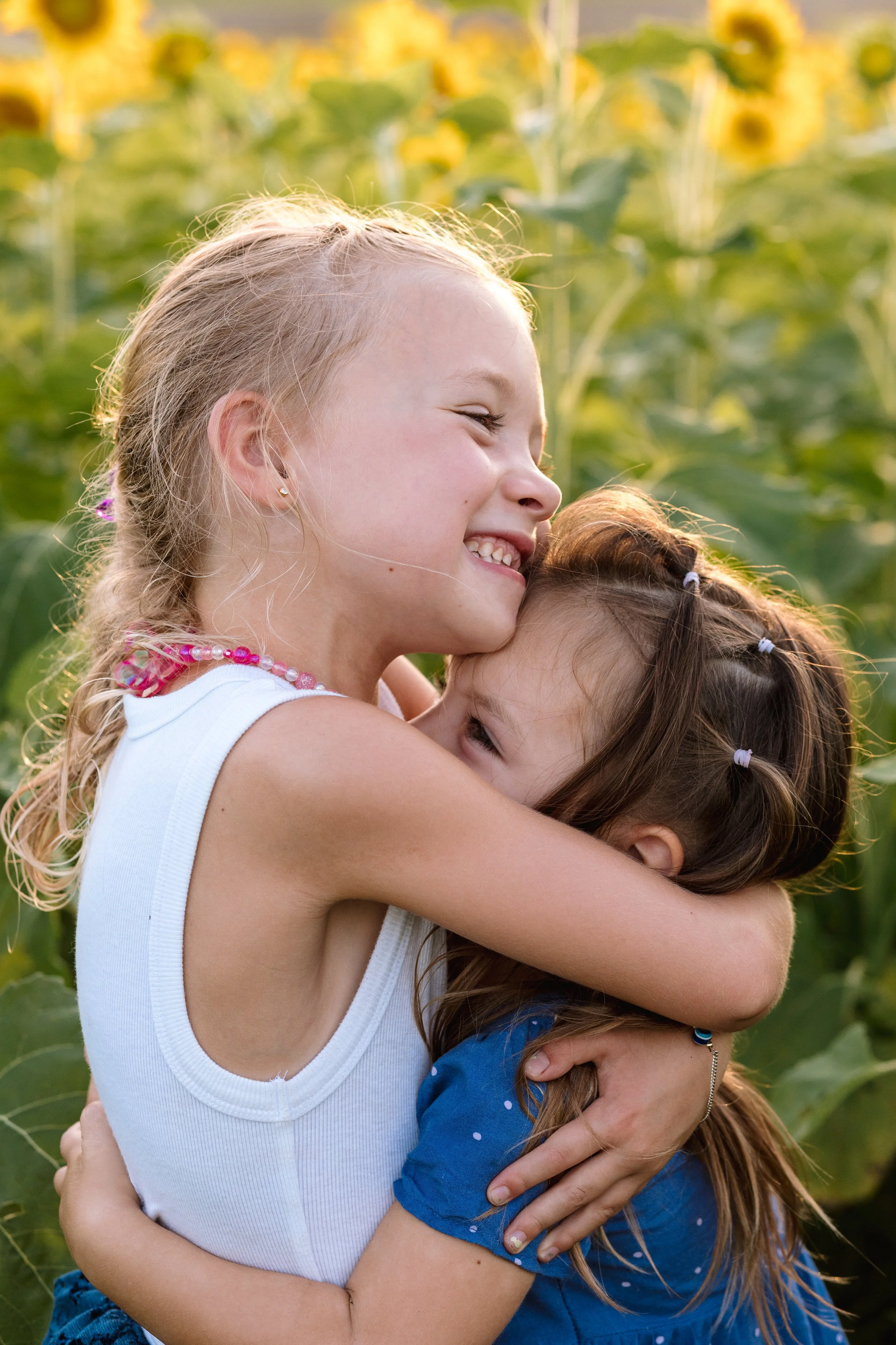 Candid sibling moment among blooming sunflowers at Burnside Farms in Northern Virginia.