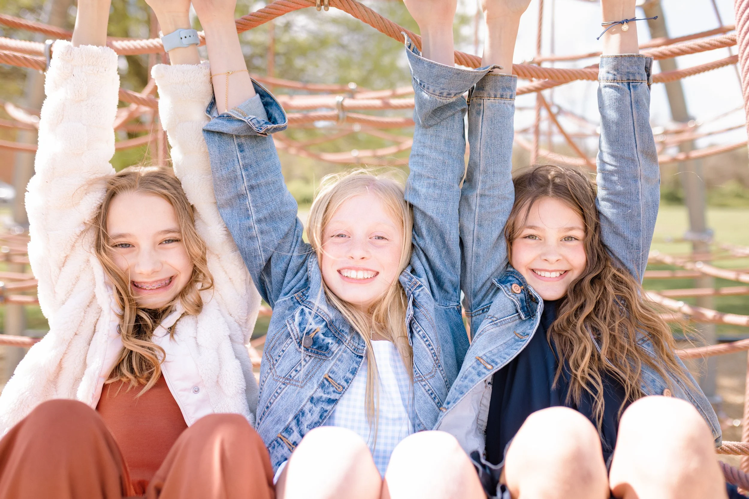 best friends are playing during a 5th grade graduation portrait session.